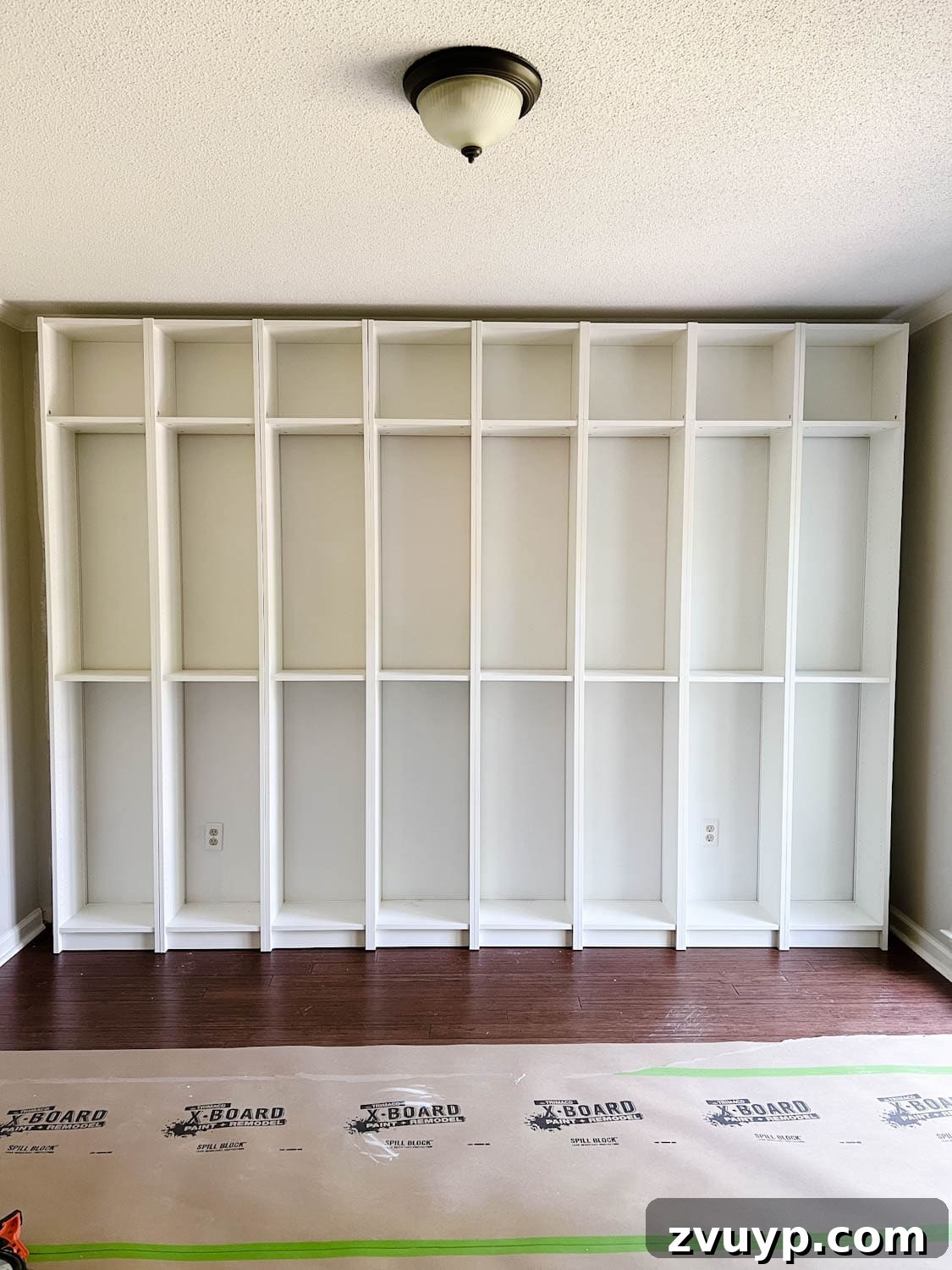 The IKEA Billy Hack: Custom Built-In Bookshelves Made Easy 12 attached and anchored bookcases to the wall to make DIY built in bookshelves