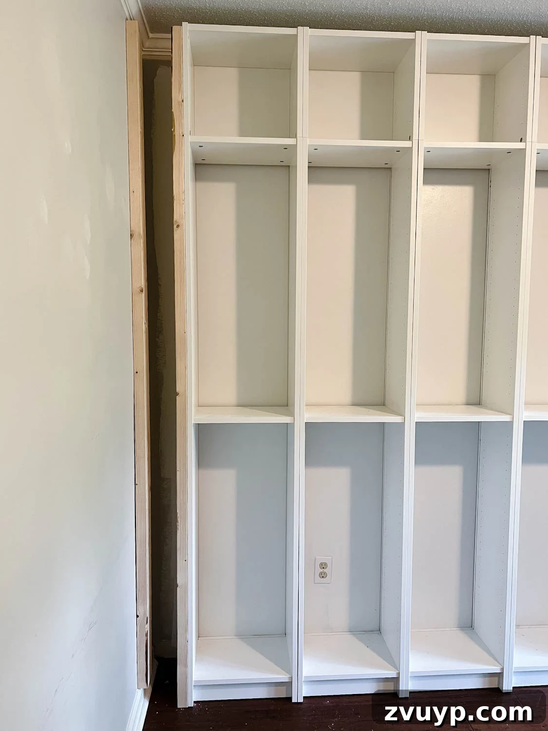 The IKEA Billy Hack: Custom Built-In Bookshelves Made Easy 13 using 2x4 boards to brace sides and fill gaps to make bookcases look built in for the IKEA Billy bookcase hack