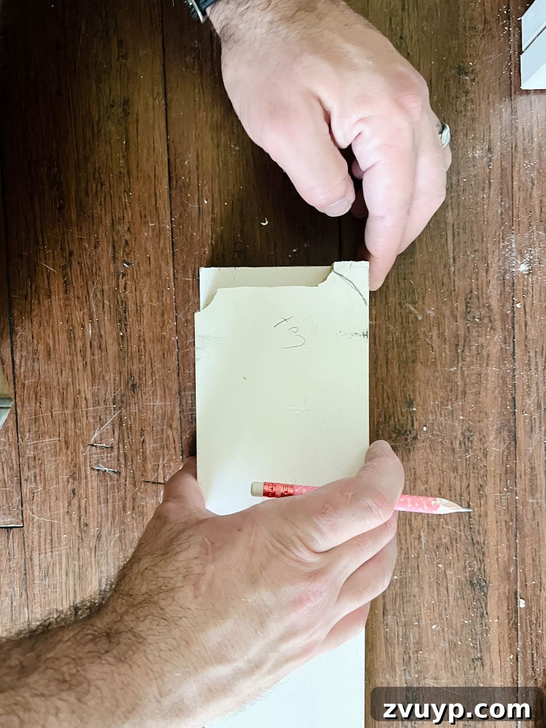 The IKEA Billy Hack: Custom Built-In Bookshelves Made Easy 16 marking the shape of a baseboard to a 1x4 board to cut