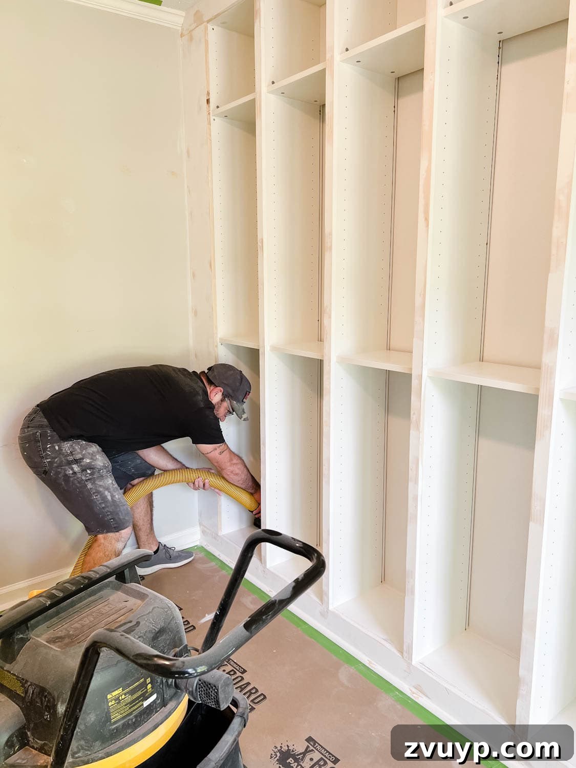 The IKEA Billy Hack: Custom Built-In Bookshelves Made Easy 25 using a shop vac to remove sanding dust from shelves