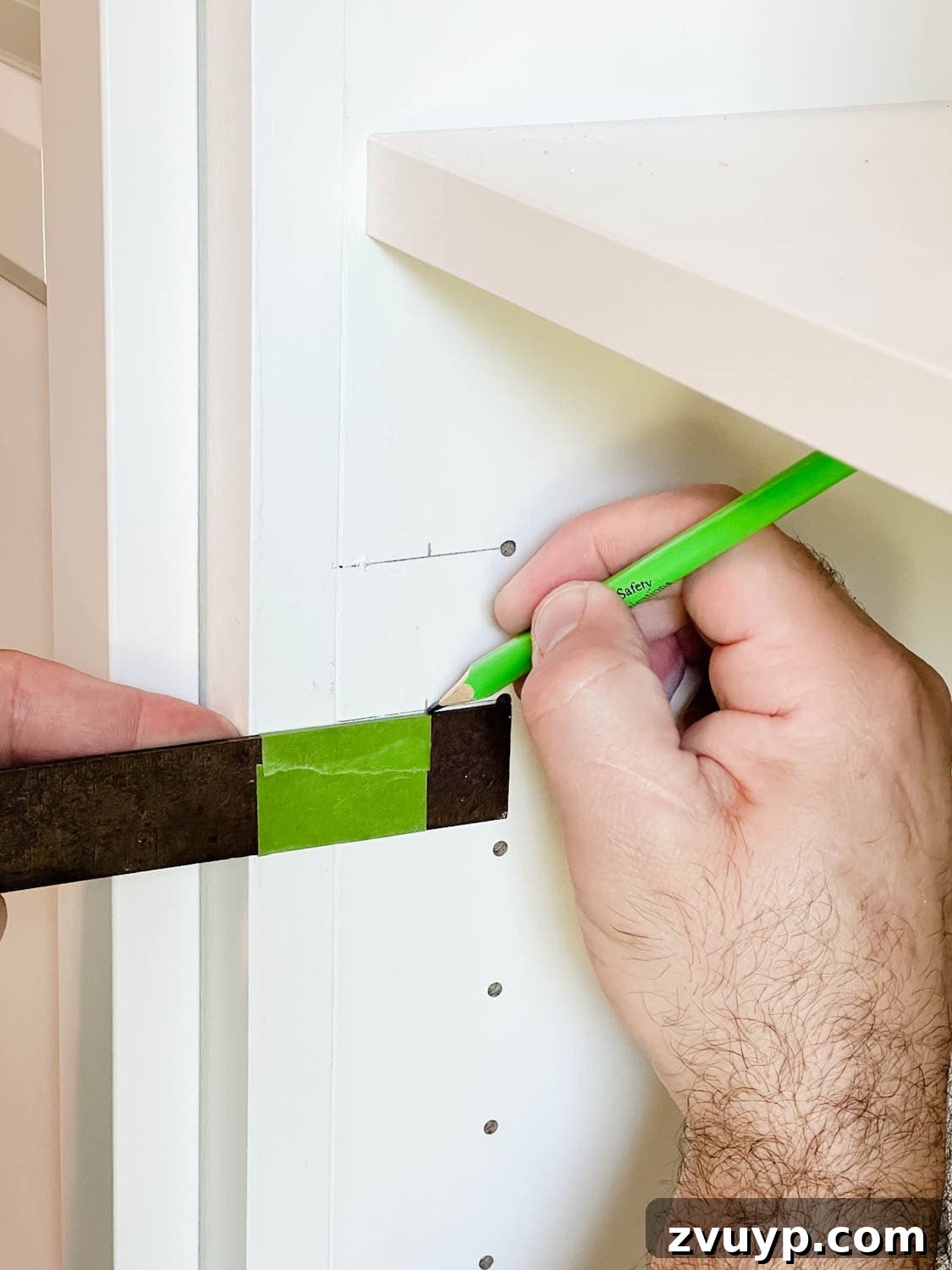 The IKEA Billy Hack: Custom Built-In Bookshelves Made Easy 29 using a combination square to mark new holes for door hardware