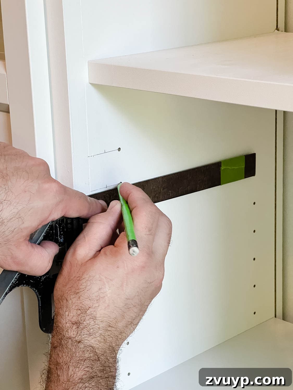 The IKEA Billy Hack: Custom Built-In Bookshelves Made Easy 30 marking new holes to drill for door hinges on shelves