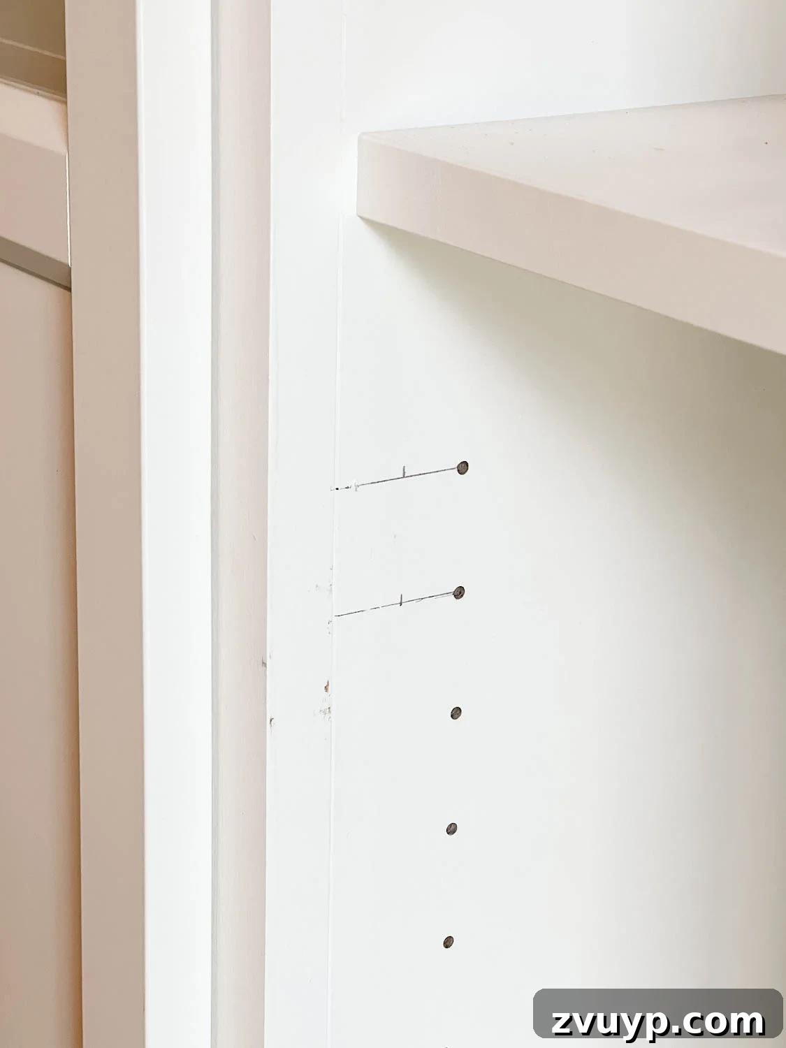 The IKEA Billy Hack: Custom Built-In Bookshelves Made Easy 31 new holes marked for drilling to hang shelf doors