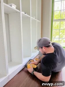The IKEA Billy Hack: Custom Built-In Bookshelves Made Easy 40 attach 1x4 boards to base of billy bookcases with brad nailer