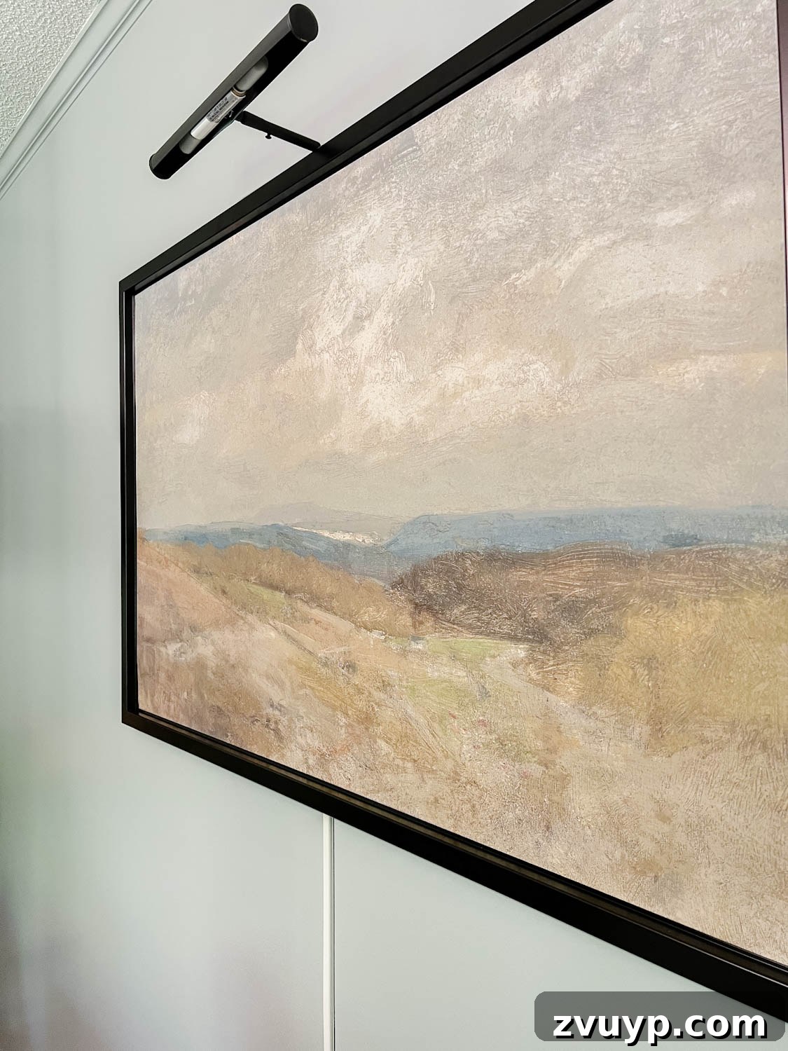 Illuminate Your Art Wirelessly: Picture Light Installation Guide 6 art light above art with cord stuck to wall below