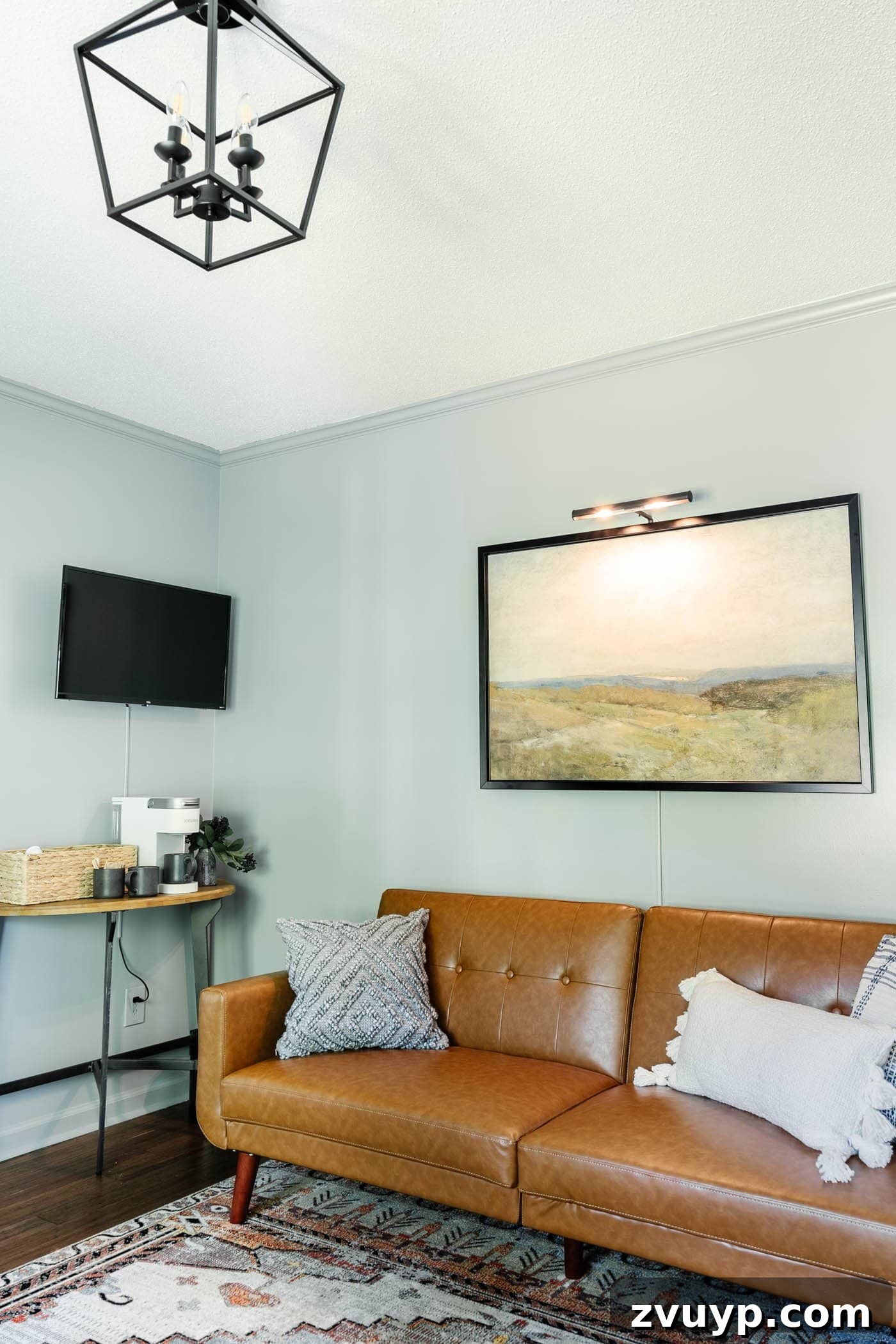 Illuminate Your Art Wirelessly: Picture Light Installation Guide 7 art with picture light above a home office lounge sofa with coffee bar table and TV