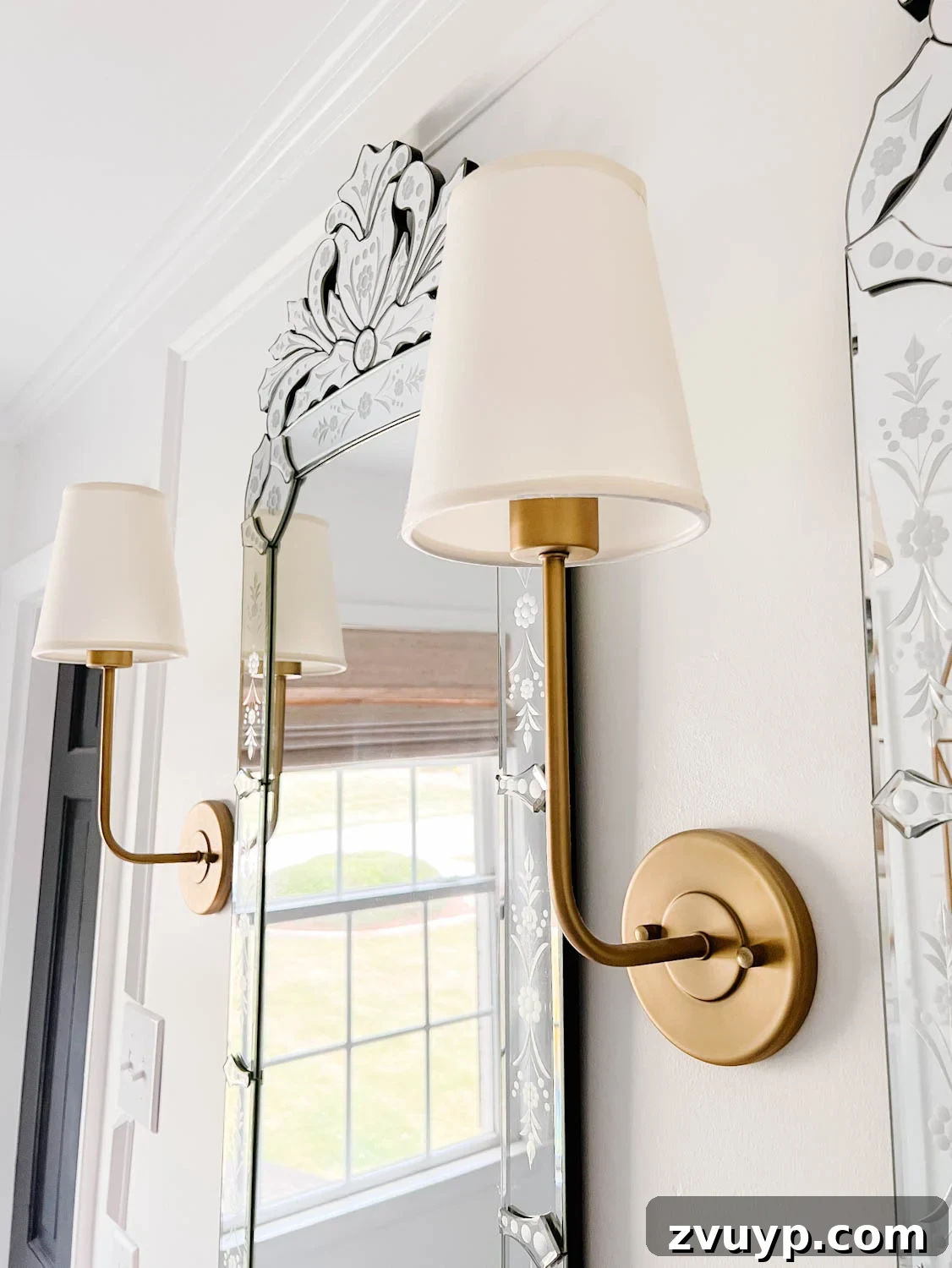 Spa Chic on a Shoestring: Elevate Your Bathroom 8 shaded sconce lights in a bathroom with Venetian mirrors