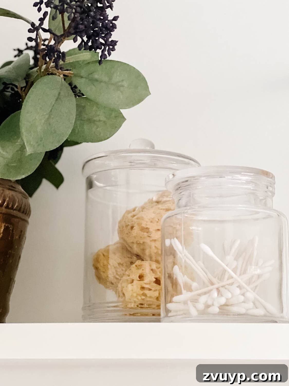 Spa Chic on a Shoestring: Elevate Your Bathroom 10 apothecary jars with q tips and bath sponges for spa bathroom storage