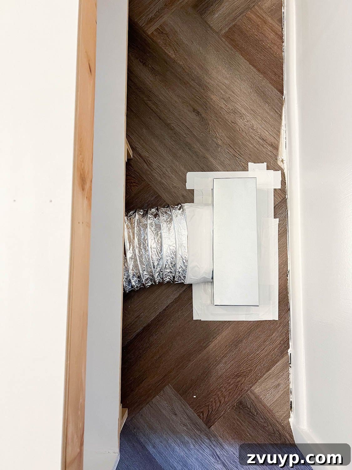 Corner Banquette Refresh and Hidden Vent Hacks 12 Completed air vent redirect setup using a Toe Ductor kit underneath a built-in bench, showing the flexible ducting and secure connections.