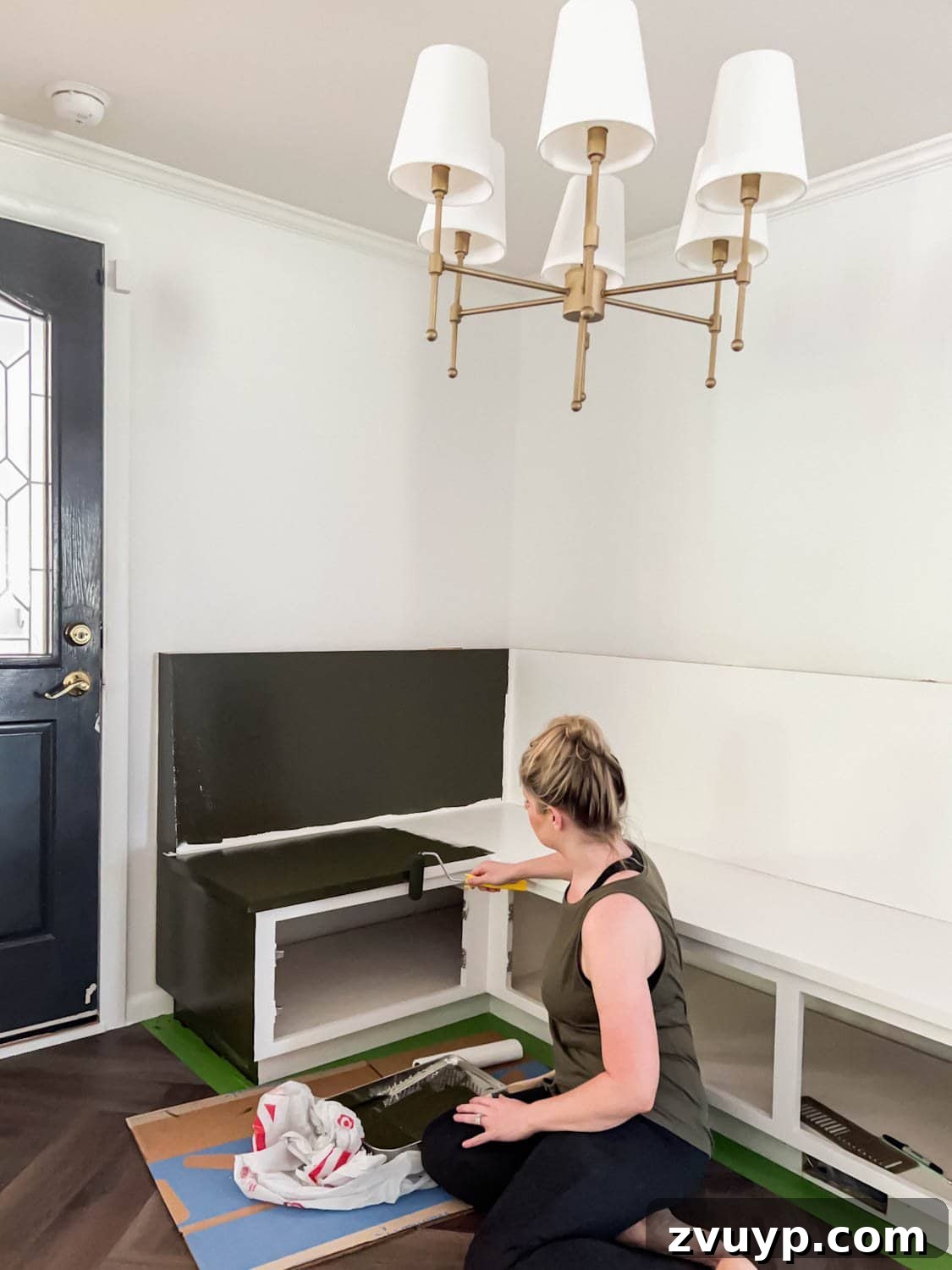 Corner Banquette Refresh and Hidden Vent Hacks 15 Applying Benjamin Moore Southern Vines paint to the corner banquette, highlighting the smooth, even coverage and transformative effect.
