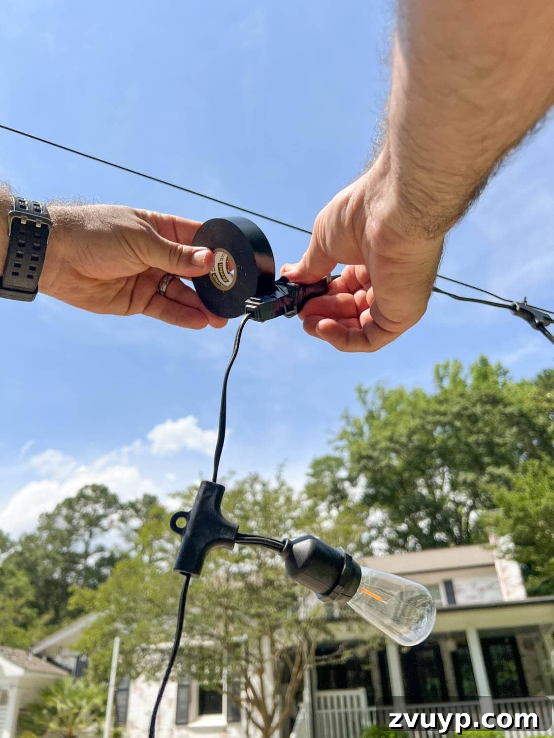 No Poles, No Problem: Creative Ways to Hang Backyard String Lights 27 wrapping two string light strand plugs with black electrical tape
