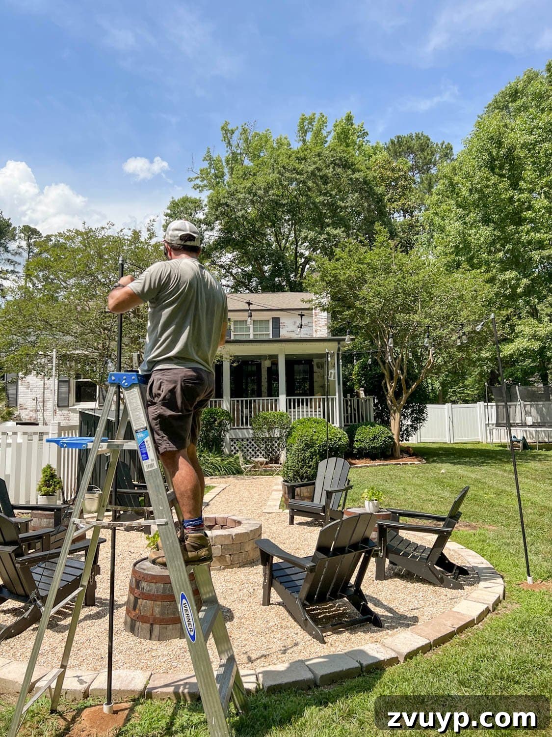No Poles, No Problem: Creative Ways to Hang Backyard String Lights 28 attaching string lights to cable around a fire pit
