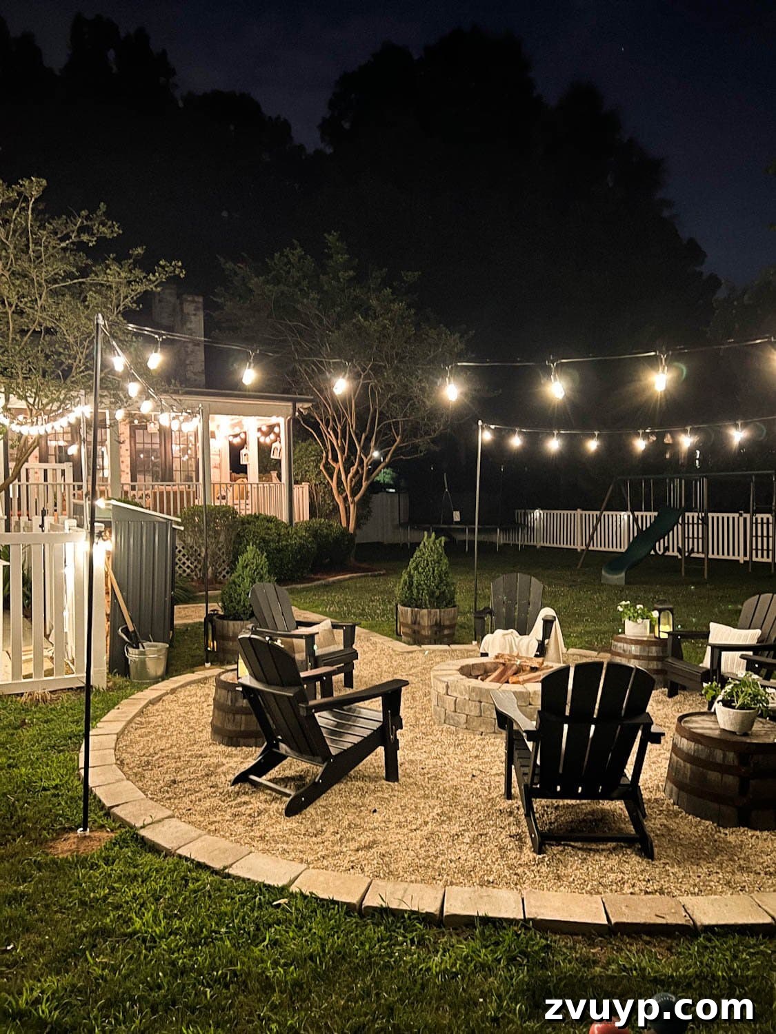 No Poles, No Problem: Creative Ways to Hang Backyard String Lights 30 fire pit at night time with string lights in a backyard
