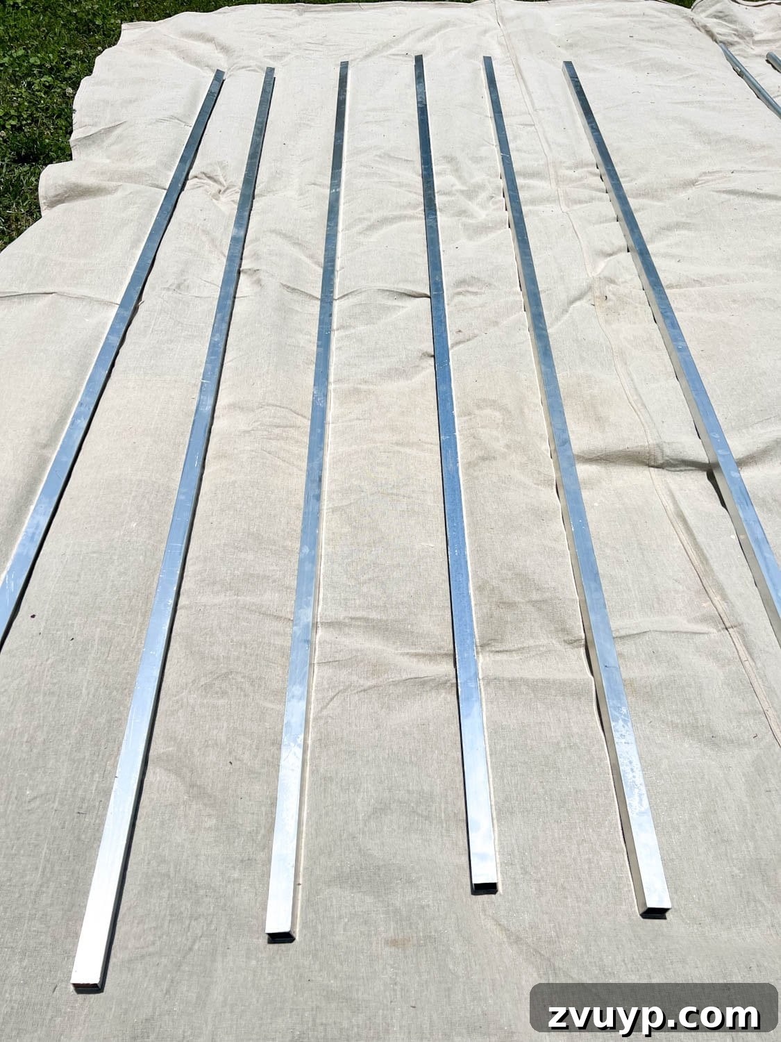 No Poles, No Problem: Creative Ways to Hang Backyard String Lights 32 square aluminum tubing on a drop cloth to be painted