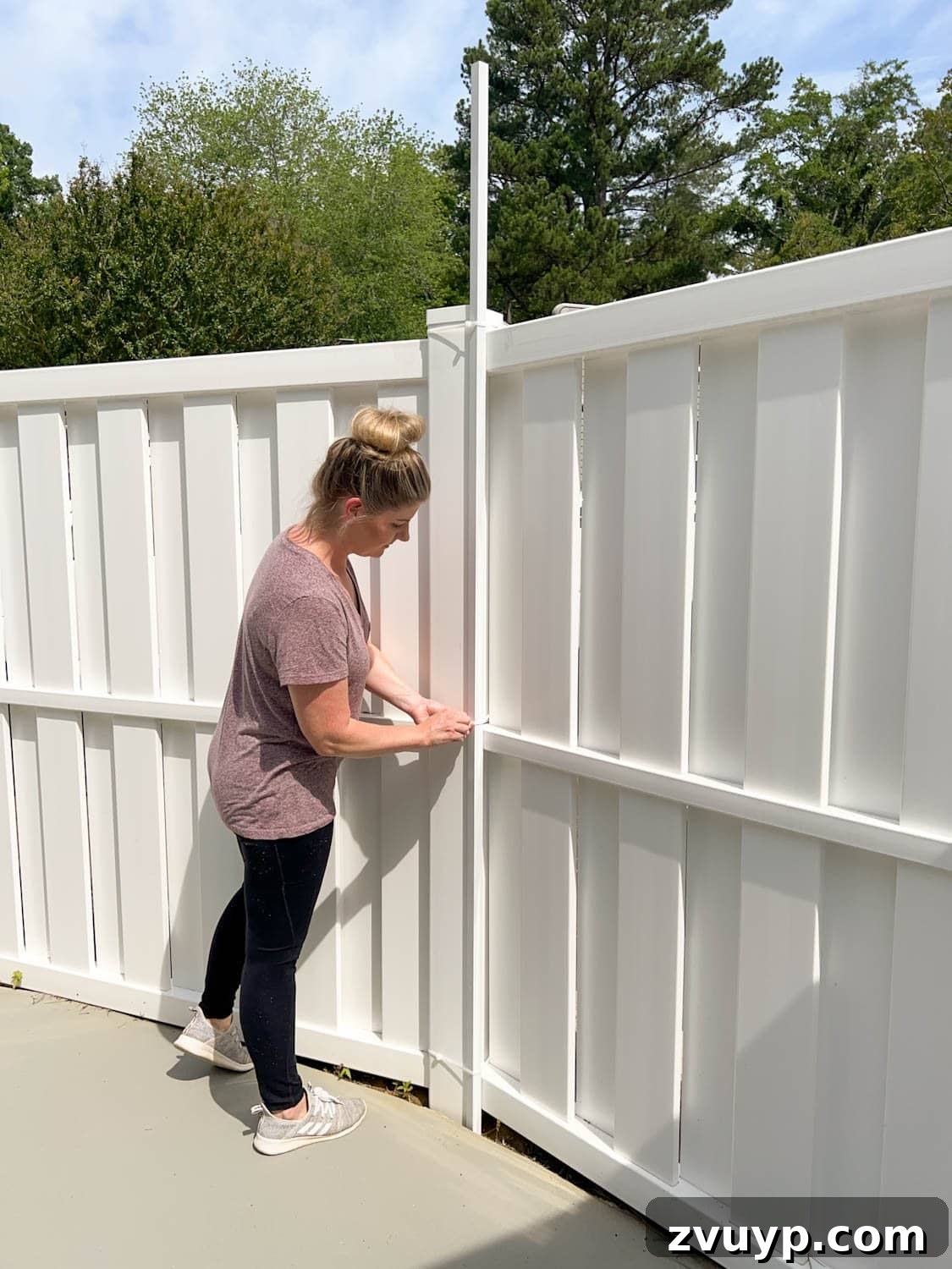 No Poles, No Problem: Creative Ways to Hang Backyard String Lights 37 placing white square tubing attached with zip ties to hang string lights on a fence