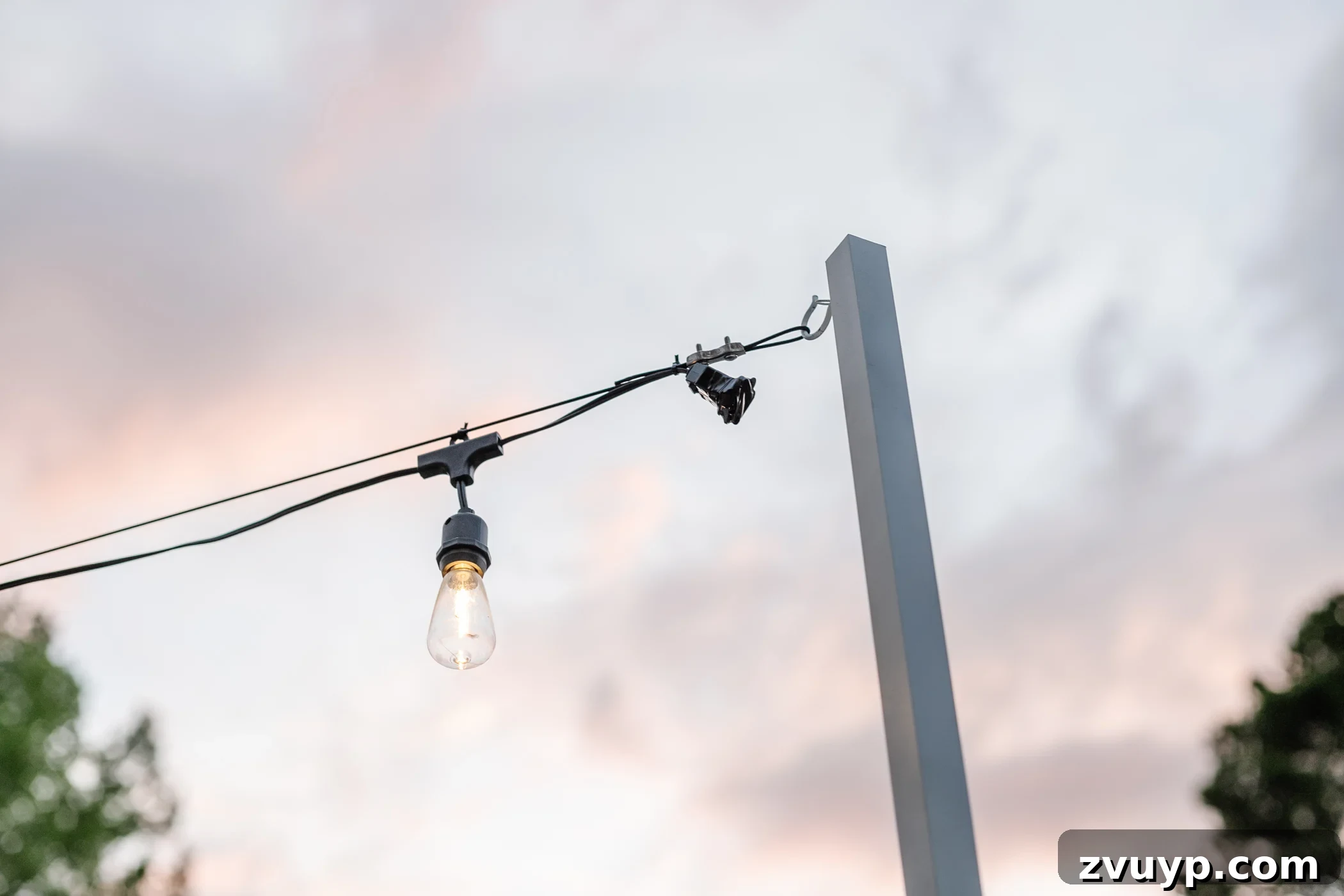 No Poles, No Problem: Creative Ways to Hang Backyard String Lights 46 end of string light strand hanging from DIY string light pole