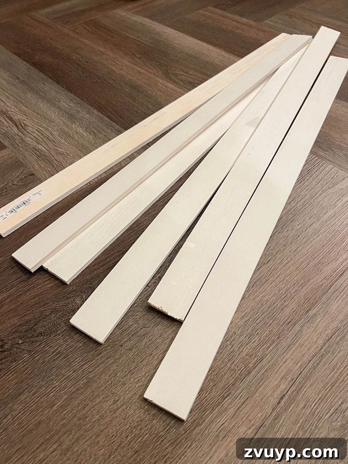 DIY Batten Wall Hack: Lattice Strips for an Affordable Look 4 A neatly stacked pile of wood lattice strips, ready for a DIY batten wall project, showcasing the material's slim and uniform appearance.