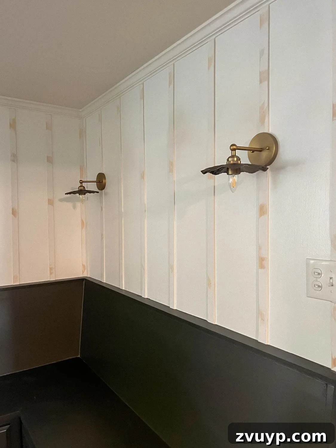 DIY Batten Wall Hack: Lattice Strips for an Affordable Look 10 A beautifully completed batten wall after the caulking, wood filling, and sanding process, showcasing a pristine, smooth surface that is ready for painting.