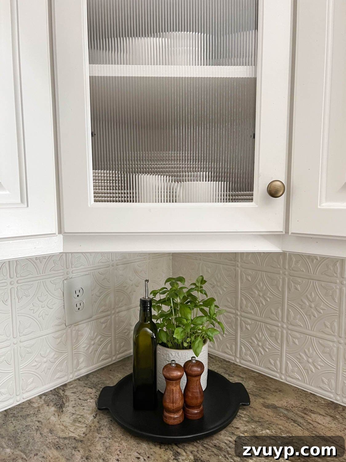 Stylish Glass on a Budget Window Film Ideas for Your Home 4 reeded glass cabinet and kitchen countertop decorative tray with potted herbs, bottle of olive oil, and salt and pepper grinders