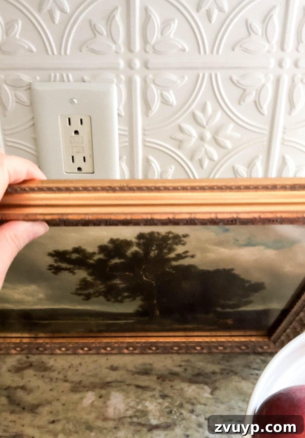 hiding a kitchen backsplash outlet with framed art