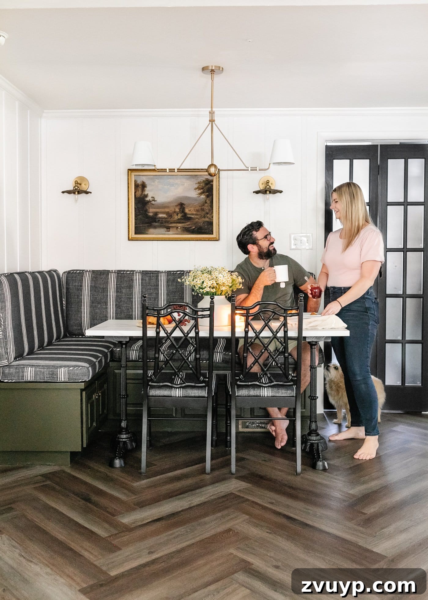 Corner Kitchen Refresh From Dated to Dazzling 4 styled breakfast nook with striped banquette bench, marble table, and herringbone LVP floors from ProCore Floors