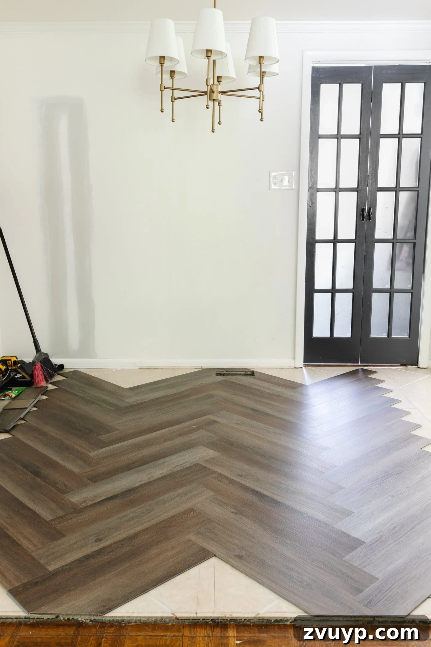 Corner Kitchen Refresh From Dated to Dazzling 7 herringbone LVP floating flooring over tile from Procore Floors
