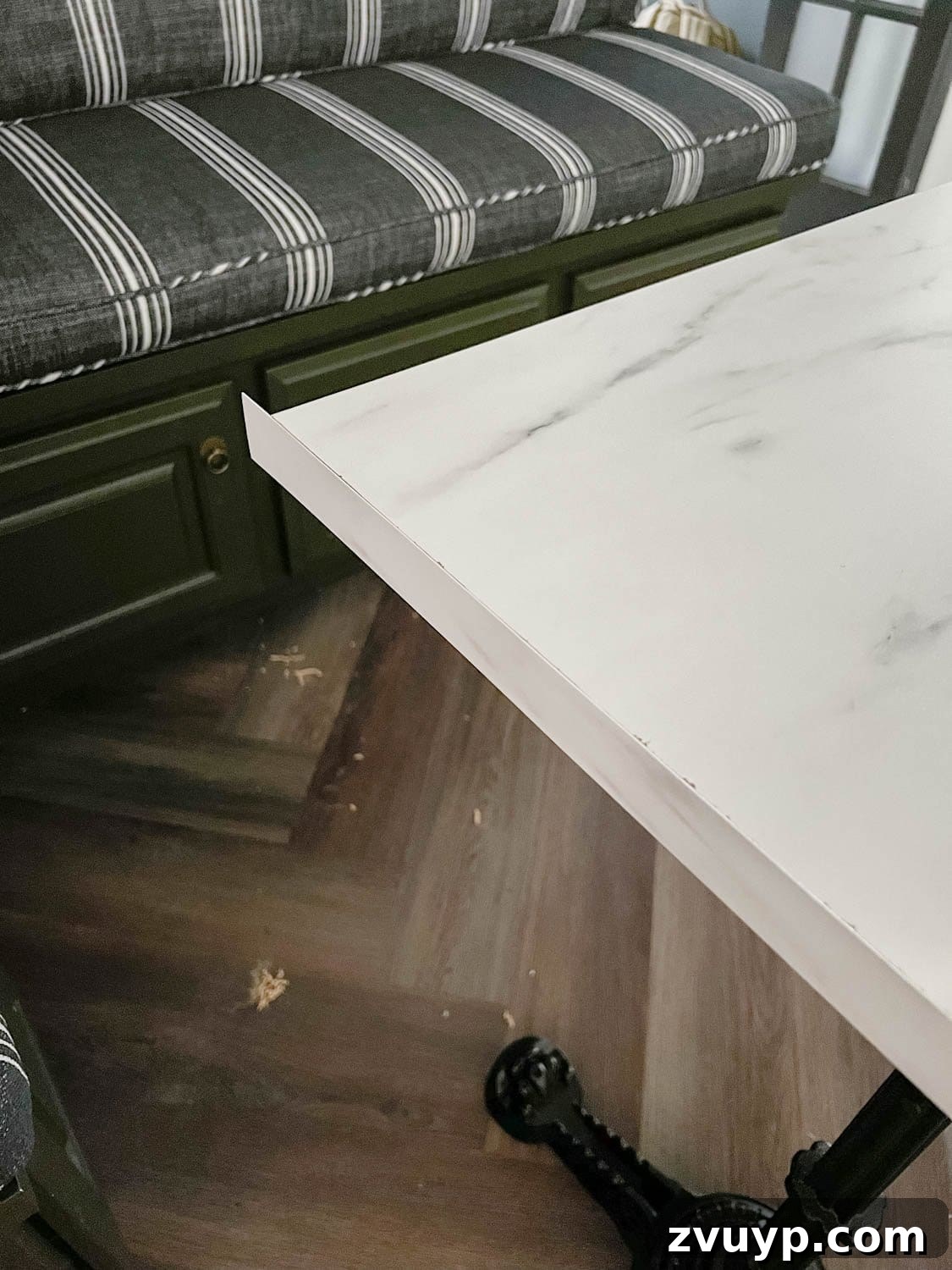 One Hour Faux Marble Dining Table Makeover 10 attaching laminate strip to a cut faux marble dining table top
