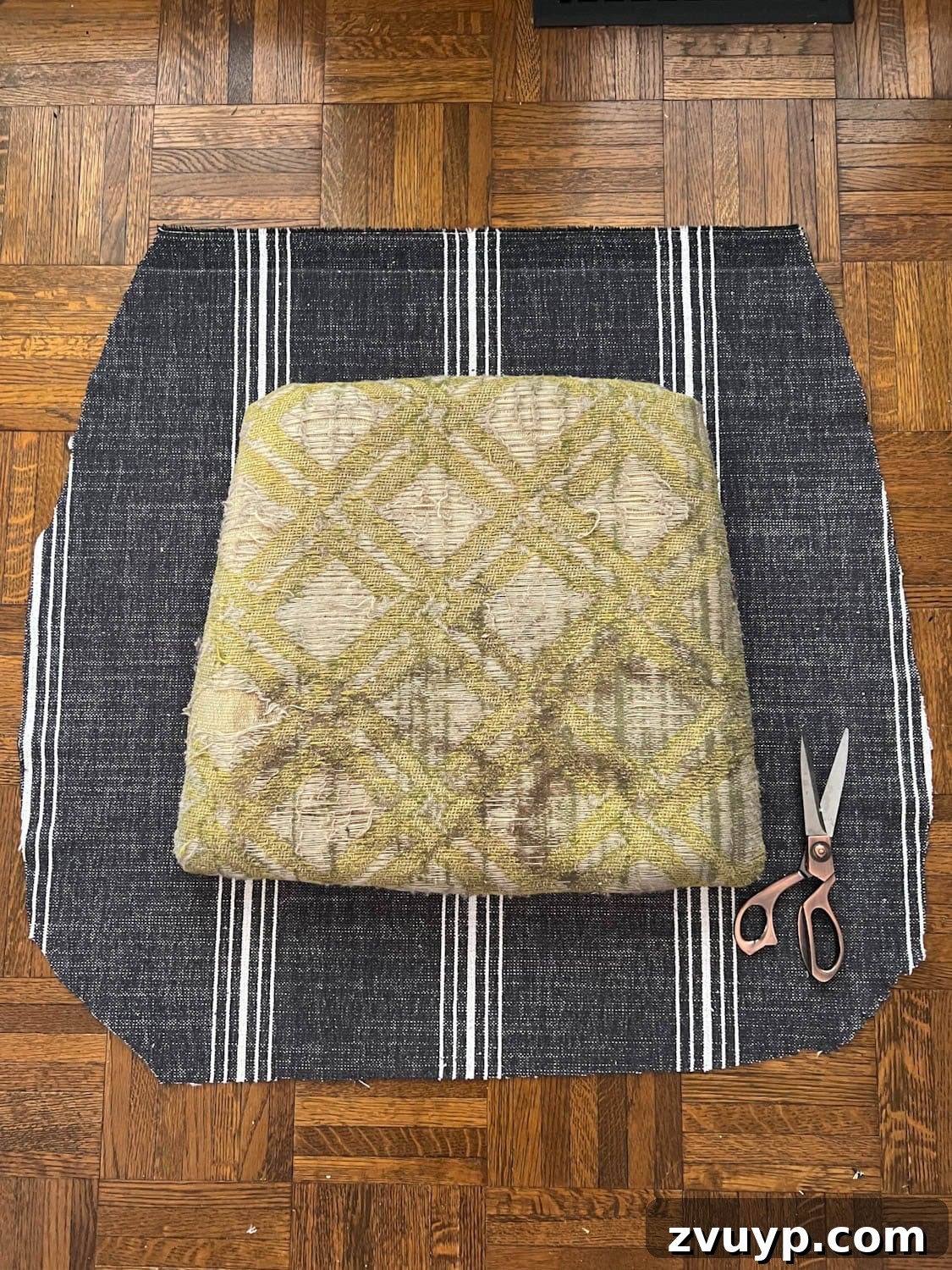 From Drab to Fab: DIY Dining Chair Reupholstery and Faux Bamboo Makeover 4 old dining chair seat on cut out upholstery fabric