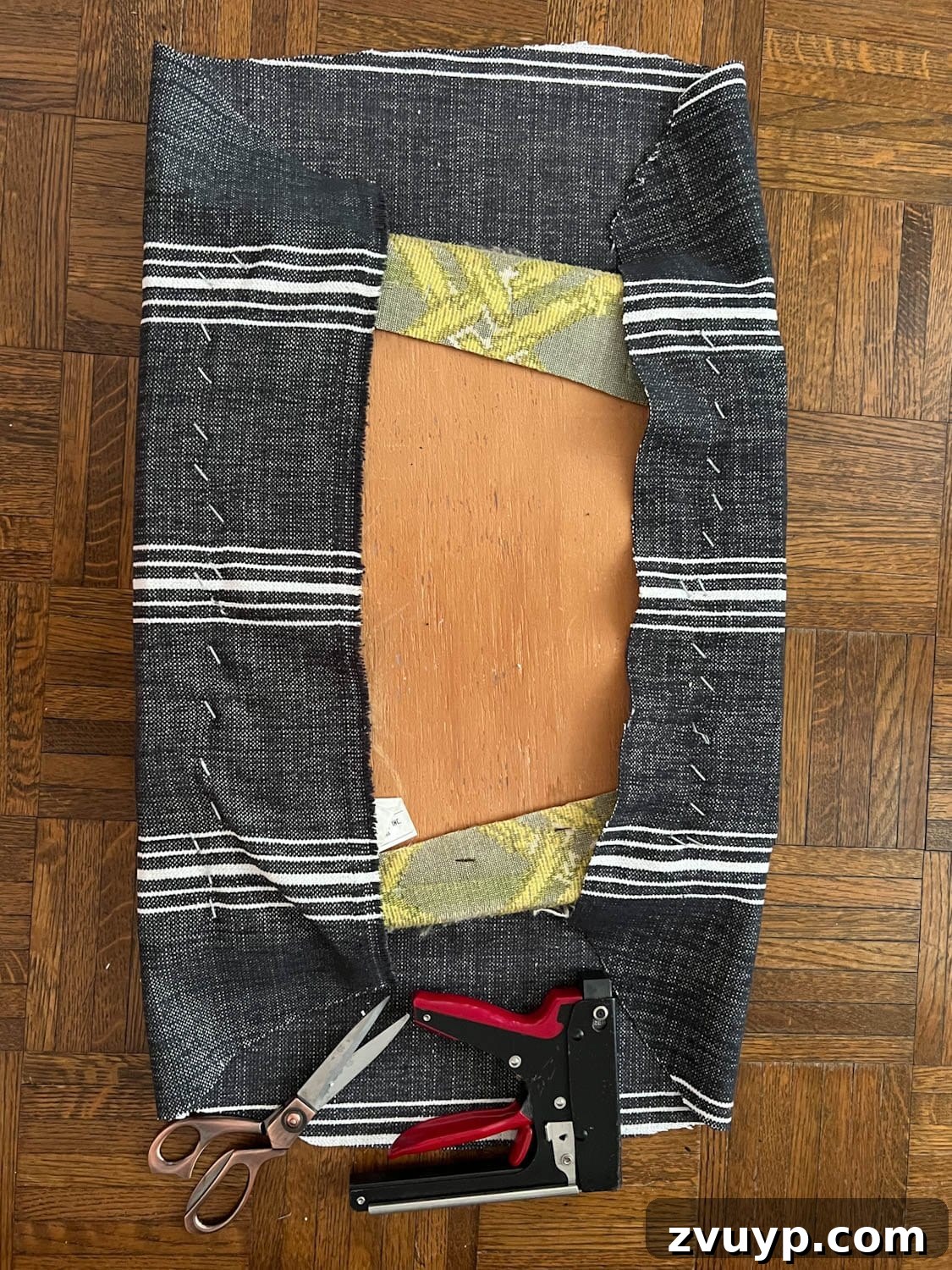 From Drab to Fab: DIY Dining Chair Reupholstery and Faux Bamboo Makeover 5 two sides of reupholstering dining chair seat using a staple gun