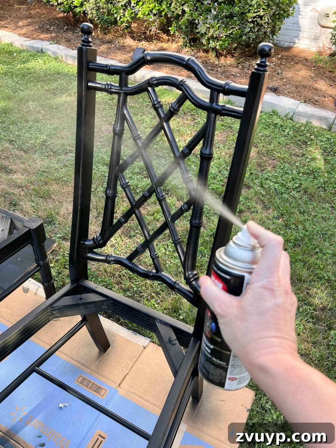 From Drab to Fab: DIY Dining Chair Reupholstery and Faux Bamboo Makeover 10 spray painting a bamboo chair with black paint