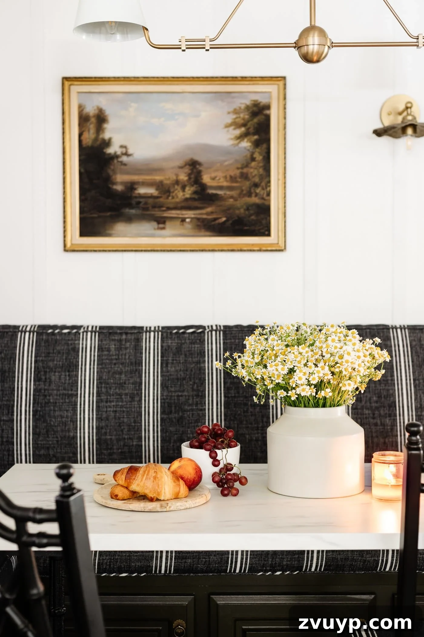 Bonjour Mornings: Your Cozy Parisian Bistro Nook 15 marble dining table with vase of daisy flowers, serving board of croissants, and bowl of grapes