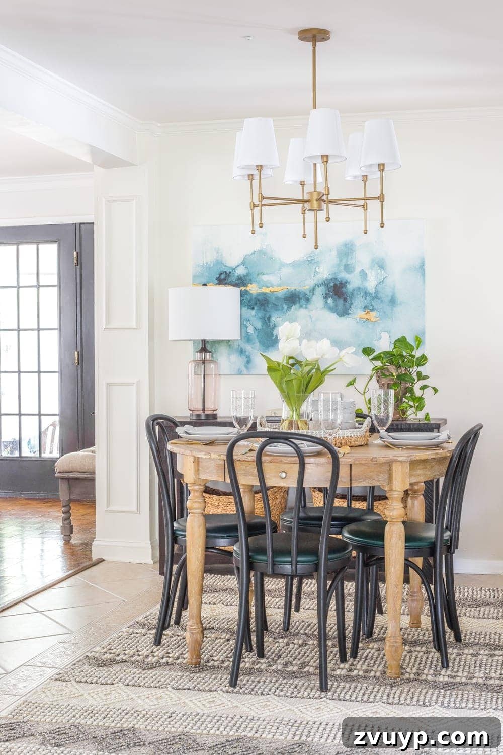 Bonjour Mornings: Your Cozy Parisian Bistro Nook 20 small dining room with black bentwood chairs, wood dining table, blue watercolor art, and brass shaded chandelier