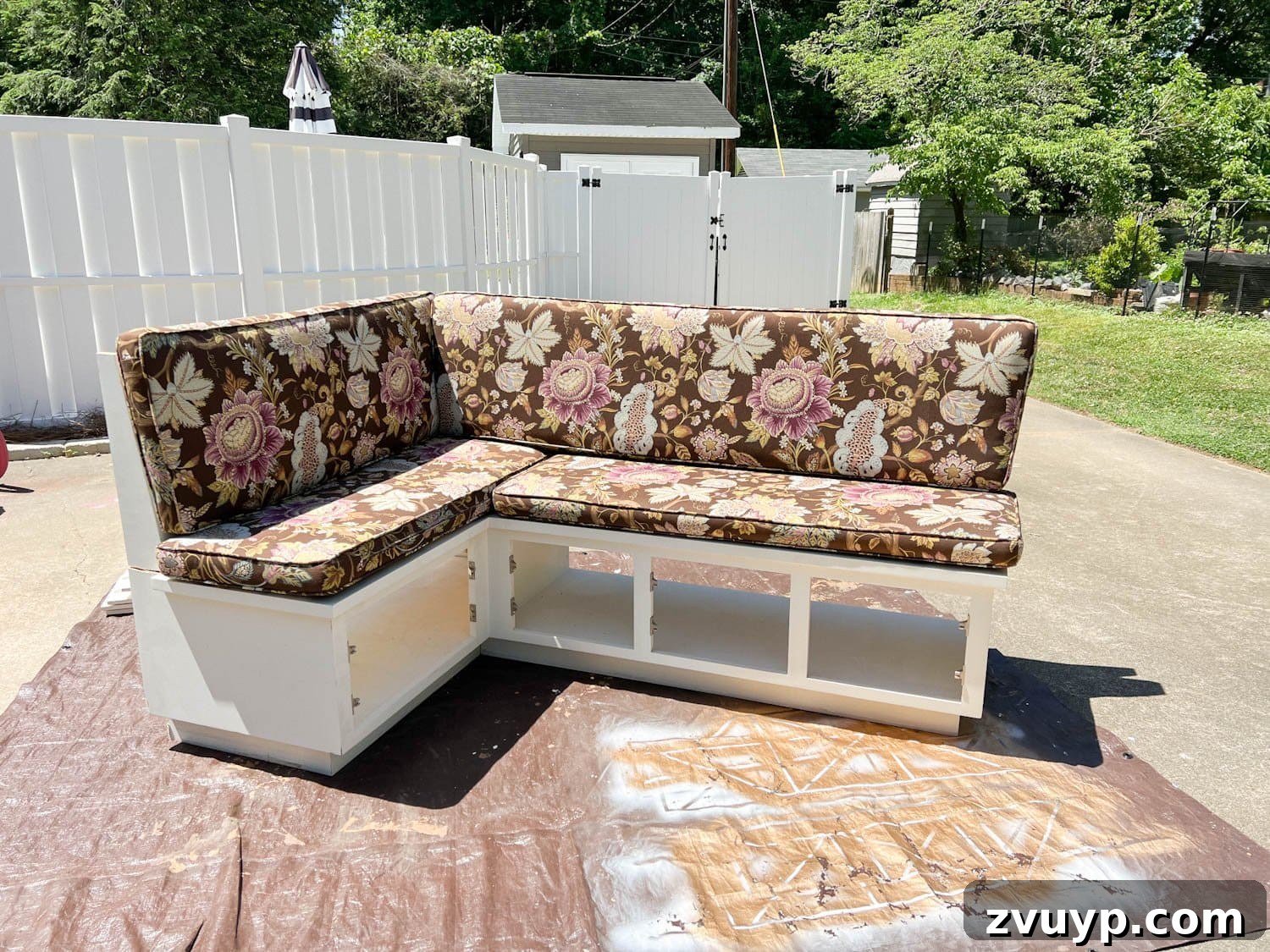 Bonjour Mornings: Your Cozy Parisian Bistro Nook 6 white thrifted banquette bench before with floral upholstered cushions