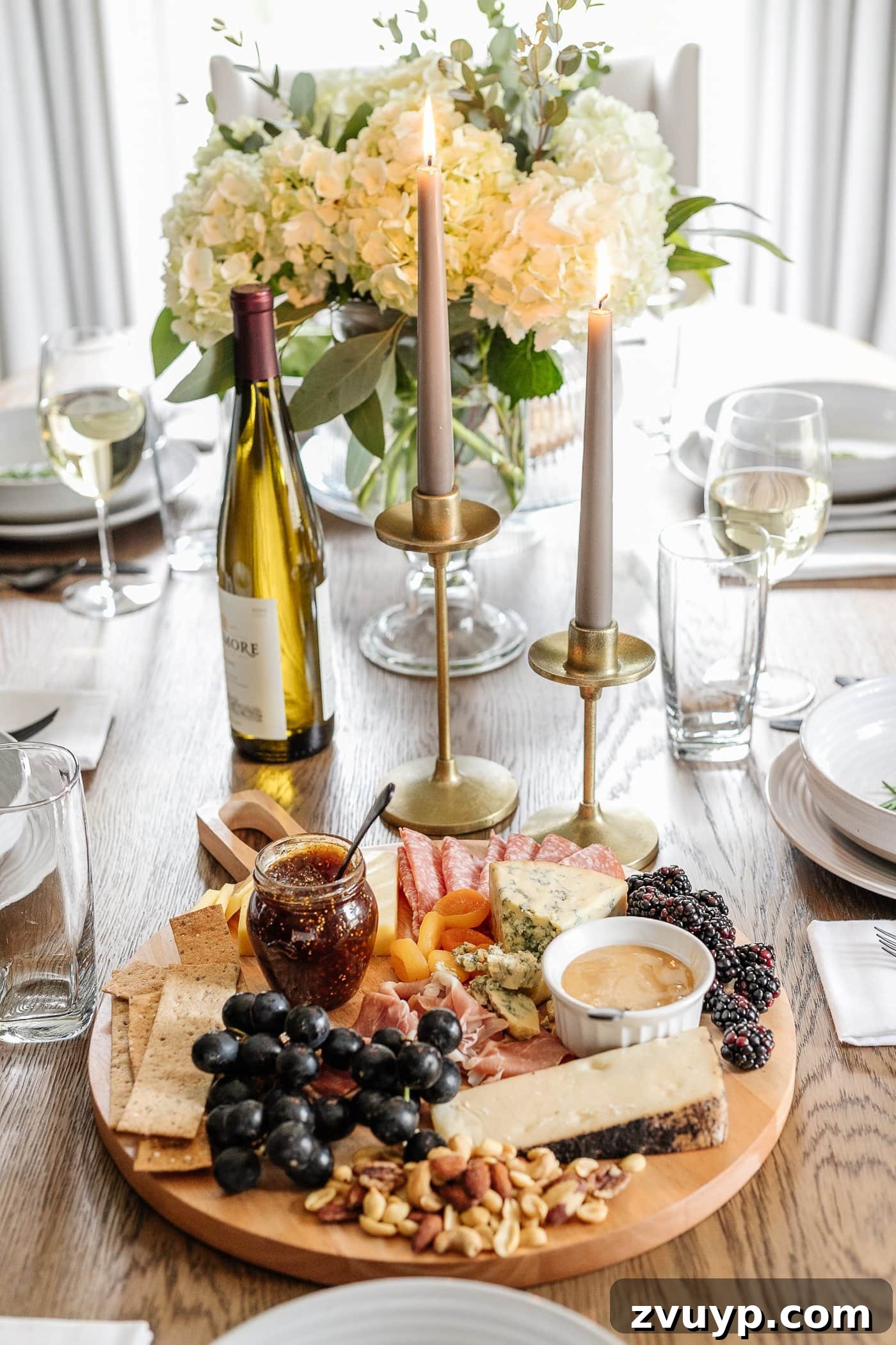 Your Go-To Guide for Flawless Table Settings, Every Time 13 a inviting dinner table setup featuring a delicious charcuterie board, elegant candlesticks, and a vase of fresh flowers for simple yet sophisticated decor
