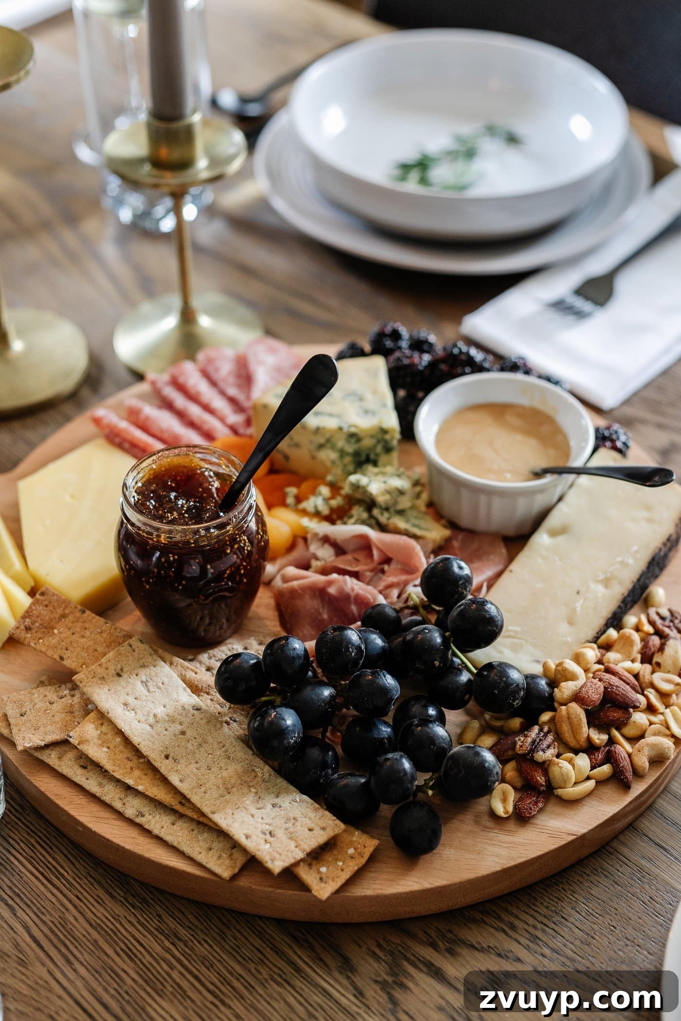 Your Go-To Guide for Flawless Table Settings, Every Time 15 a richly arranged charcuterie board laden with a variety of meats, cheeses, crackers, jams, fresh fruit, nuts, and a drizzle of honey