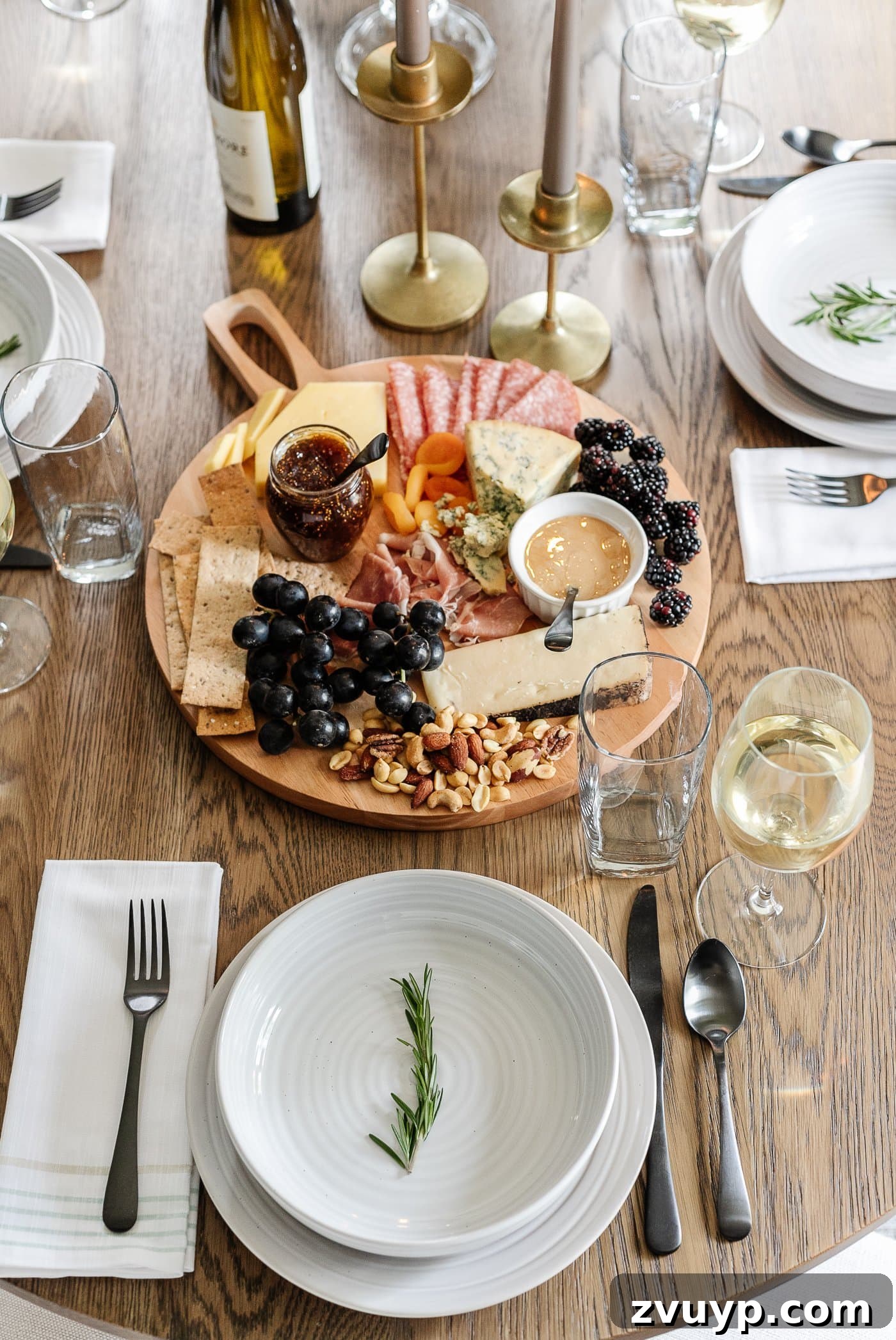 Your Go-To Guide for Flawless Table Settings, Every Time 6 a stylish charcuterie board alongside a simple place setting featuring elegant gray dishes and a fresh rosemary sprig