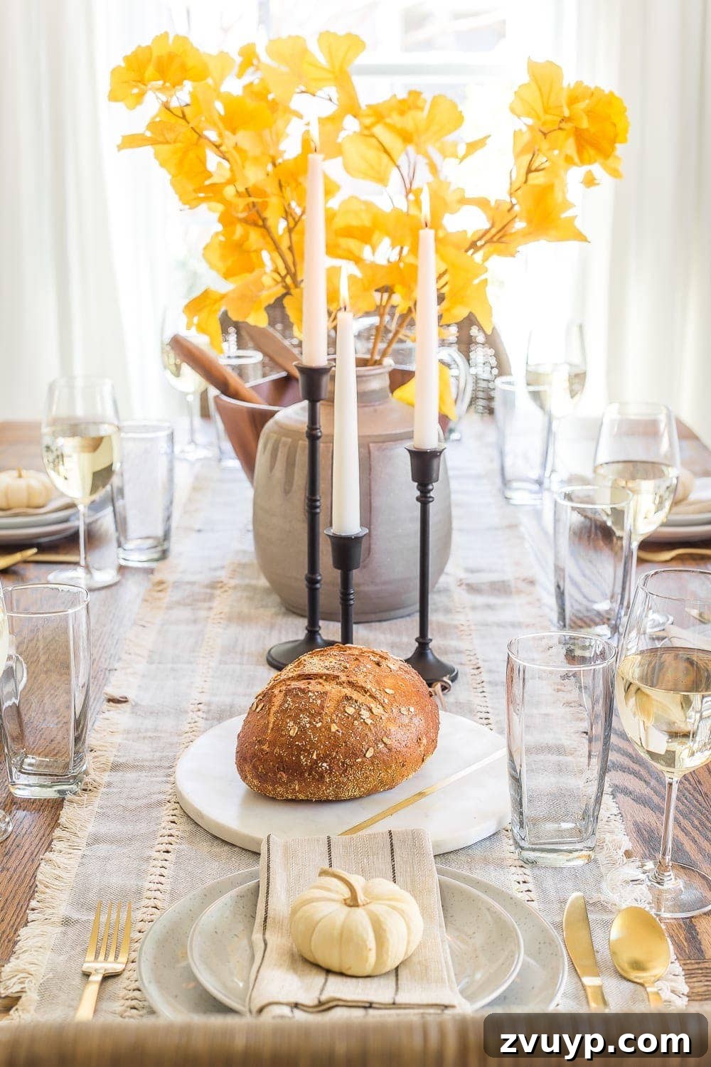 Your Go-To Guide for Flawless Table Settings, Every Time 10 a beautiful fall dinner table decor setup featuring a vase filled with vibrant ginkgo stems, creating a striking seasonal centerpiece
