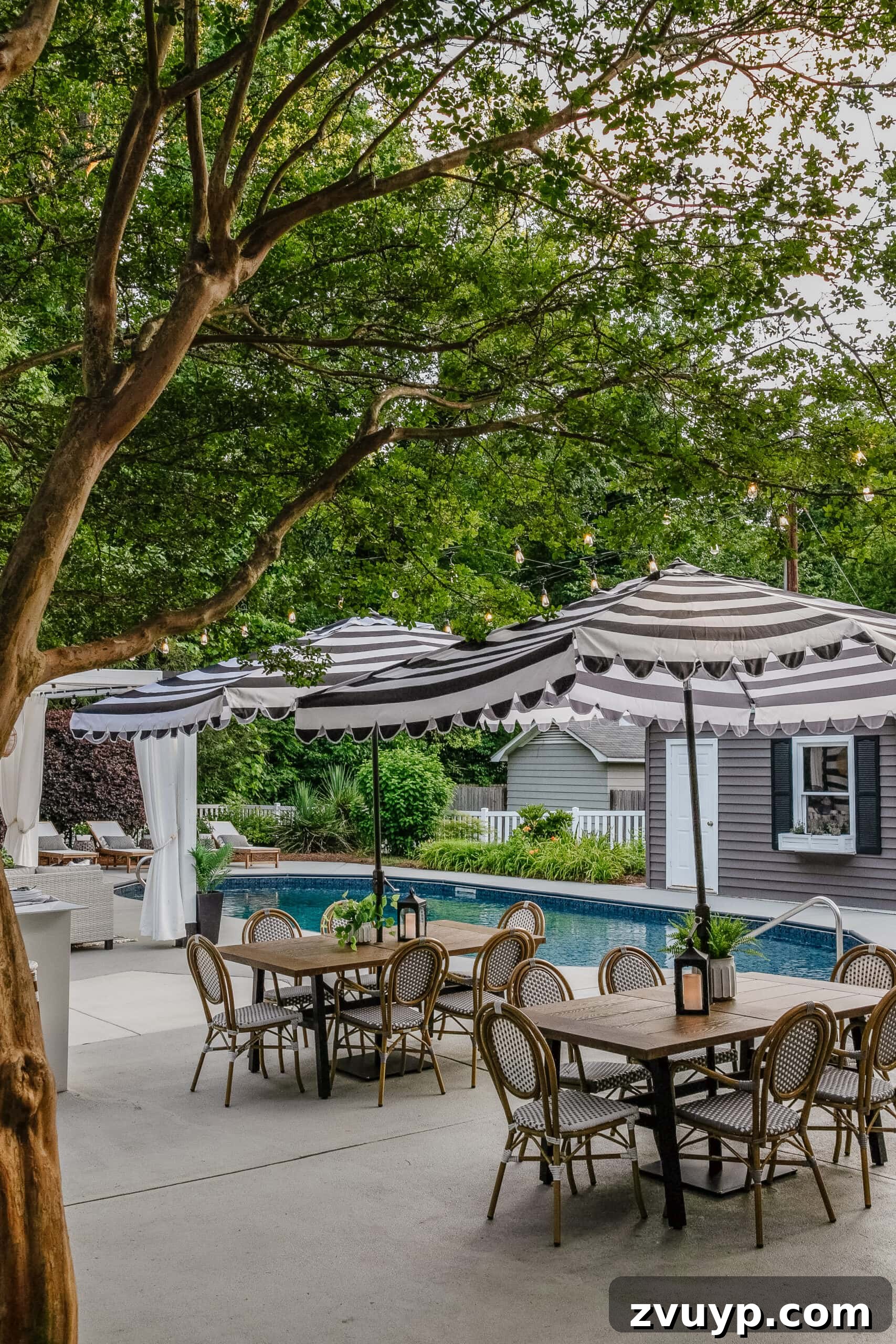 Our Home's Incredible 5-Year Transformation Tour 84 stunning backyard swimming pool area featuring elegant outdoor dining sets, a chic striped umbrella, a refreshed pool shed with painted vinyl siding, a beautifully painted concrete deck, comfortable poolside patio furniture, and a stylish cabana, creating a luxurious and inviting outdoor retreat