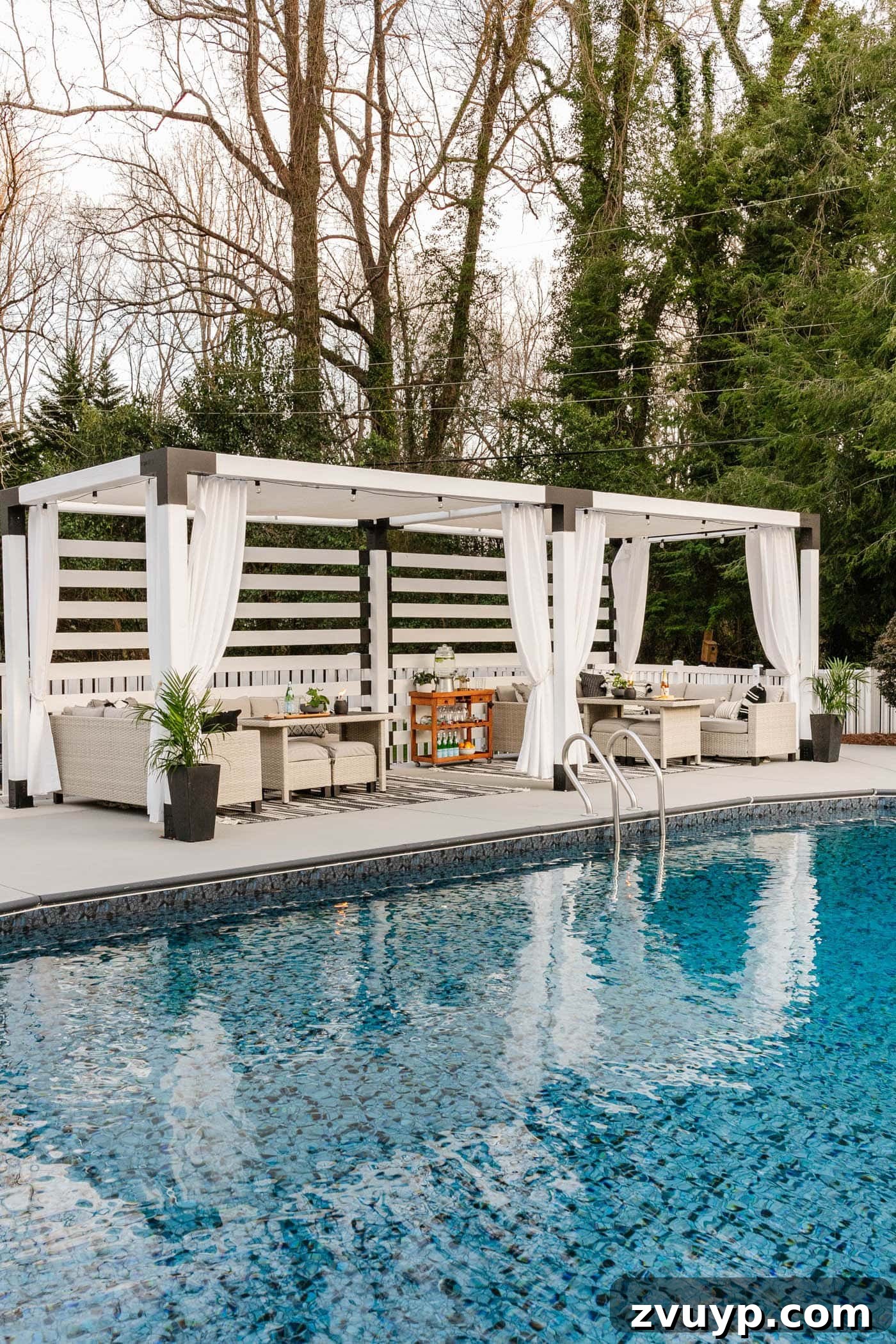 Our Home's Incredible 5-Year Transformation Tour 86 luxurious backyard swimming pool featuring a freshly painted concrete deck, comfortable poolside patio furniture, and an elegant cabana, creating an inviting and stylish outdoor space