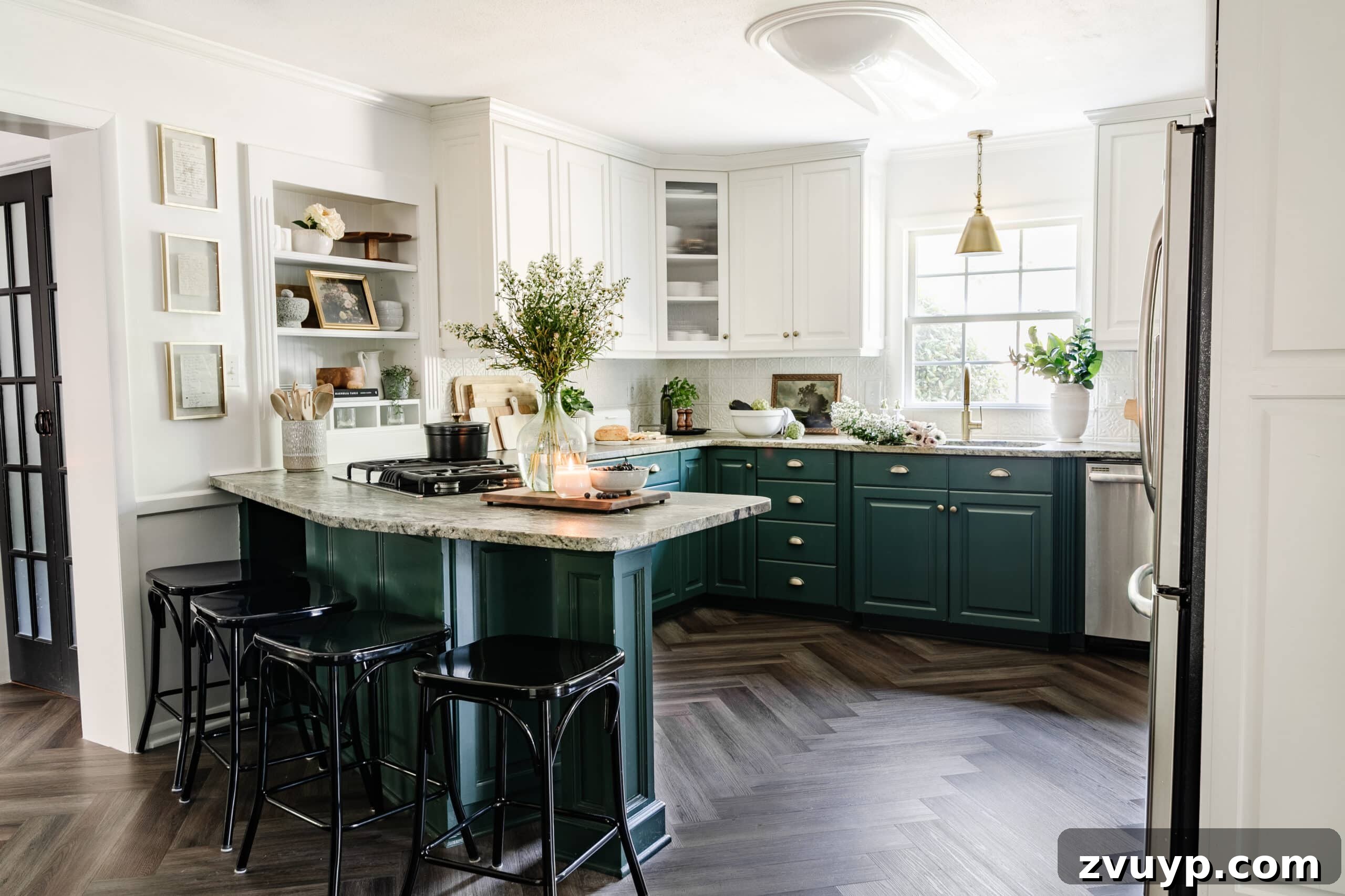 Our Home's Incredible 5-Year Transformation Tour 20 charming white and green kitchen cabinets paired with elegant herringbone wood floors, a stylish brass faucet, a statement brass pendant light, and brass hardware, all contributing to a delightful cottagecore style aesthetic