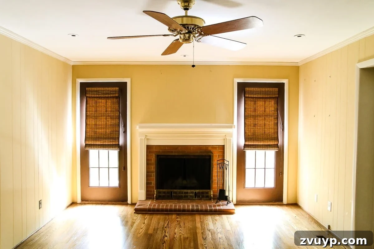 Our Home's Incredible 5-Year Transformation Tour 37 before playroom with bright yellow and white walls, featuring an original brick fireplace