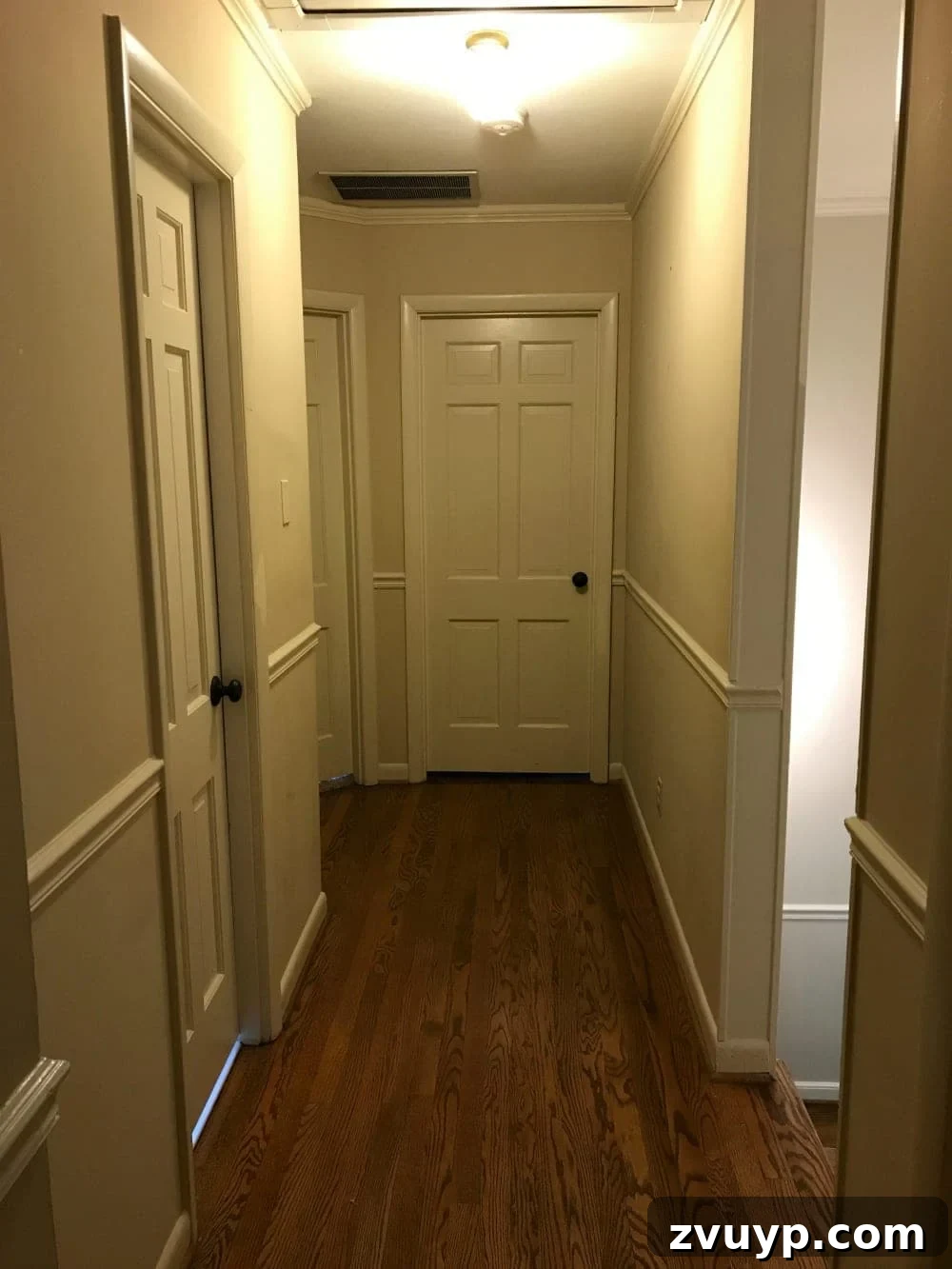 Our Home's Incredible 5-Year Transformation Tour 46 before hallway with dull beige walls and an uninviting atmosphere