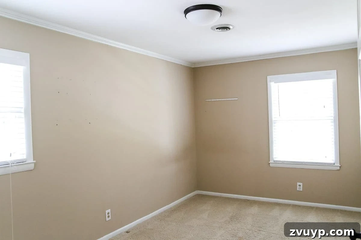 Our Home's Incredible 5-Year Transformation Tour 57 before guest bedroom with plain beige walls, lacking character and comfort