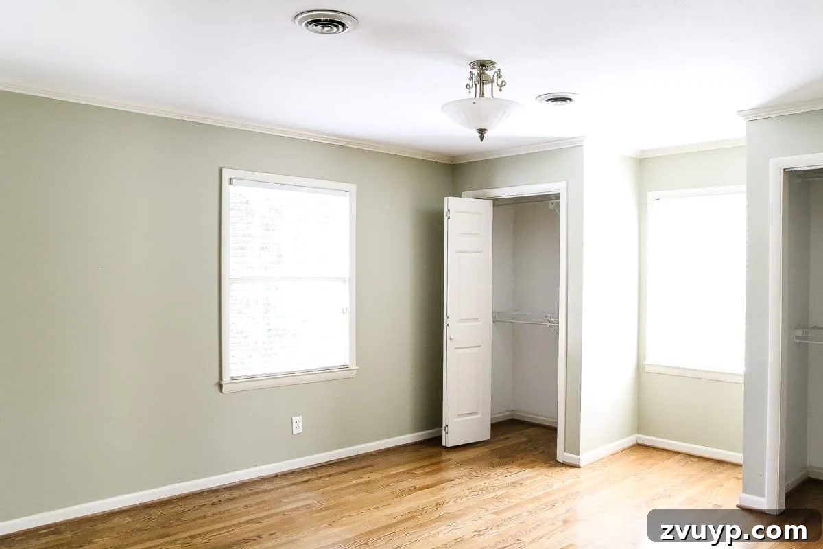 Our Home's Incredible 5-Year Transformation Tour 65 before green bedroom with plain walls, appearing uninspired and dated