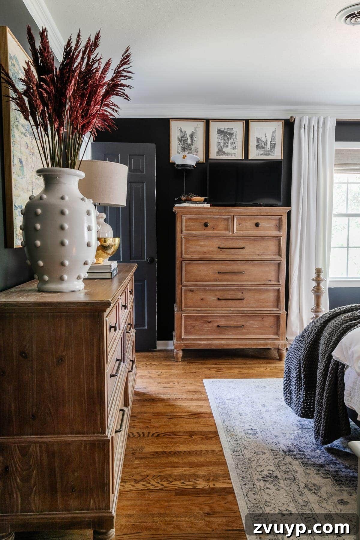 Our Home's Incredible 5-Year Transformation Tour 67 luxurious black bedroom featuring pristine white curtains, elegant mirrored closet doors, a modern ceiling fan, and a plush upholstered wood bed, creating a dramatic and comfortable sanctuary