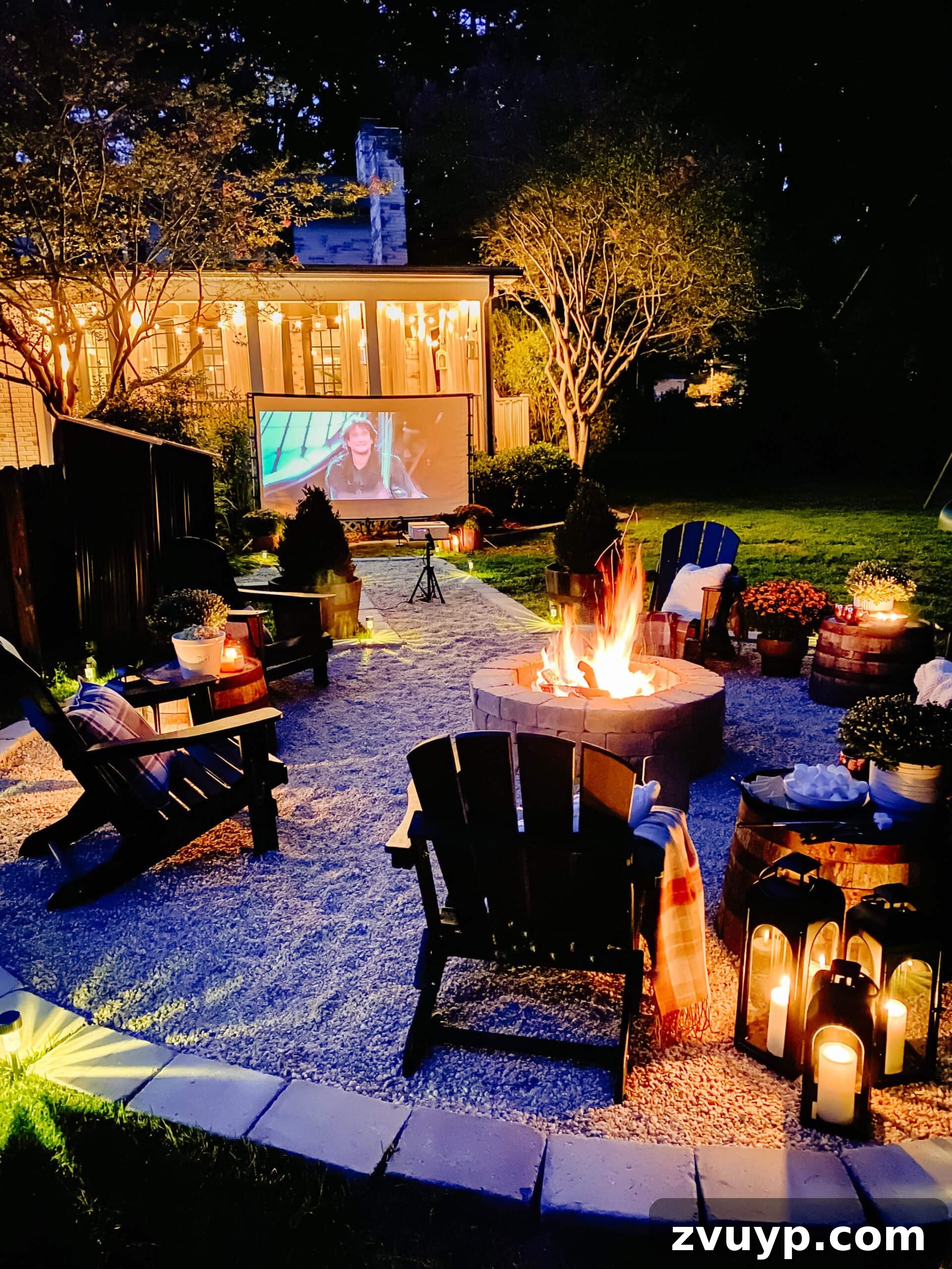 Top 100 Outdoor Films for an Unforgettable Backyard Cinema Experience 7 a backyard movie night setup around a fire pit with mums, blankets, and fall decor