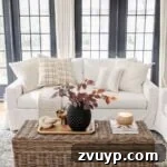 fall pillows a couch in a living room with fall leaves in a vase on a woven coffee table