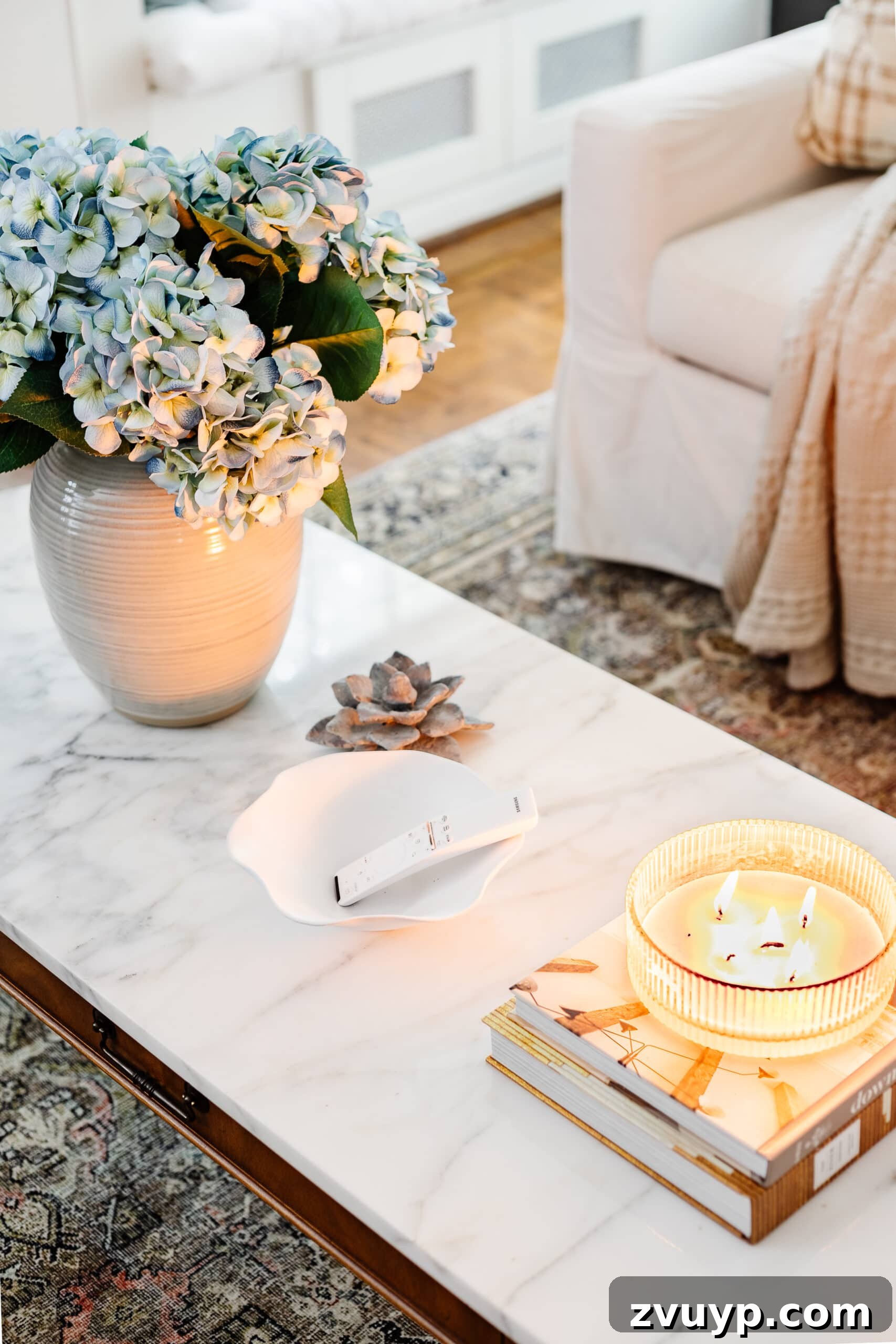 Scalloped Bowl Trend: White Spray Paint Thrift Flip 5 Decorative scalloped bowl on a coffee table, effectively holding TV remotes and other small living room essentials.