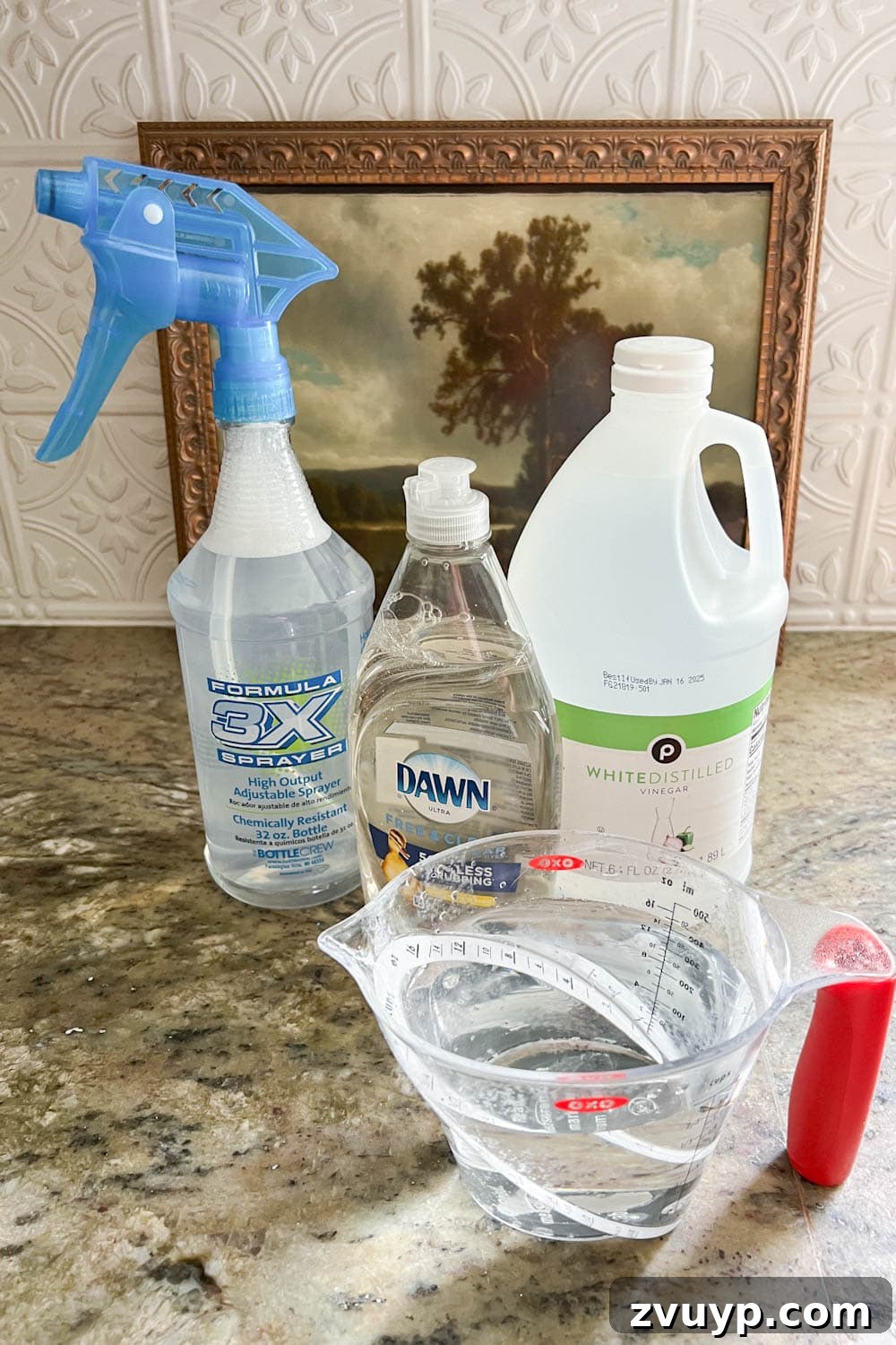 Revive Your Fabric Furniture The Ultimate Upholstery Deep Clean 11 A spray bottle containing a DIY couch cleaner solution made with water, white vinegar, and dish soap.