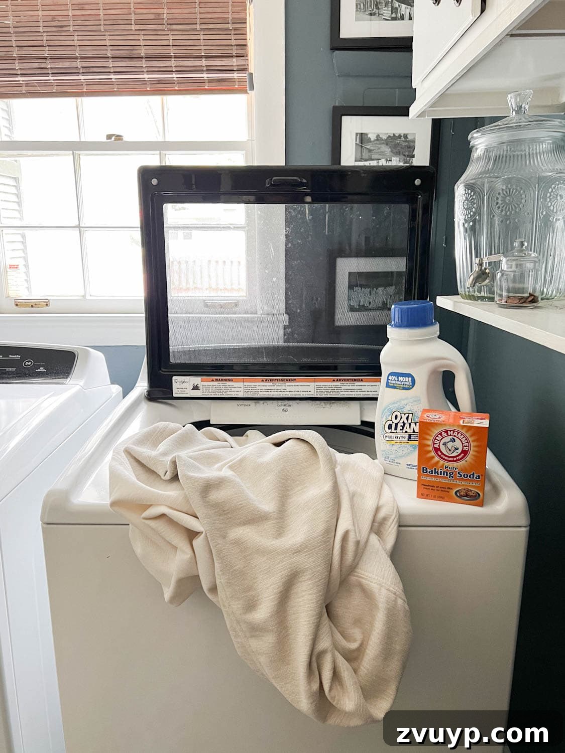 Revive Your Fabric Furniture The Ultimate Upholstery Deep Clean 6 White cushion covers being washed in a washing machine with cleaning agents for a thorough cleaning.